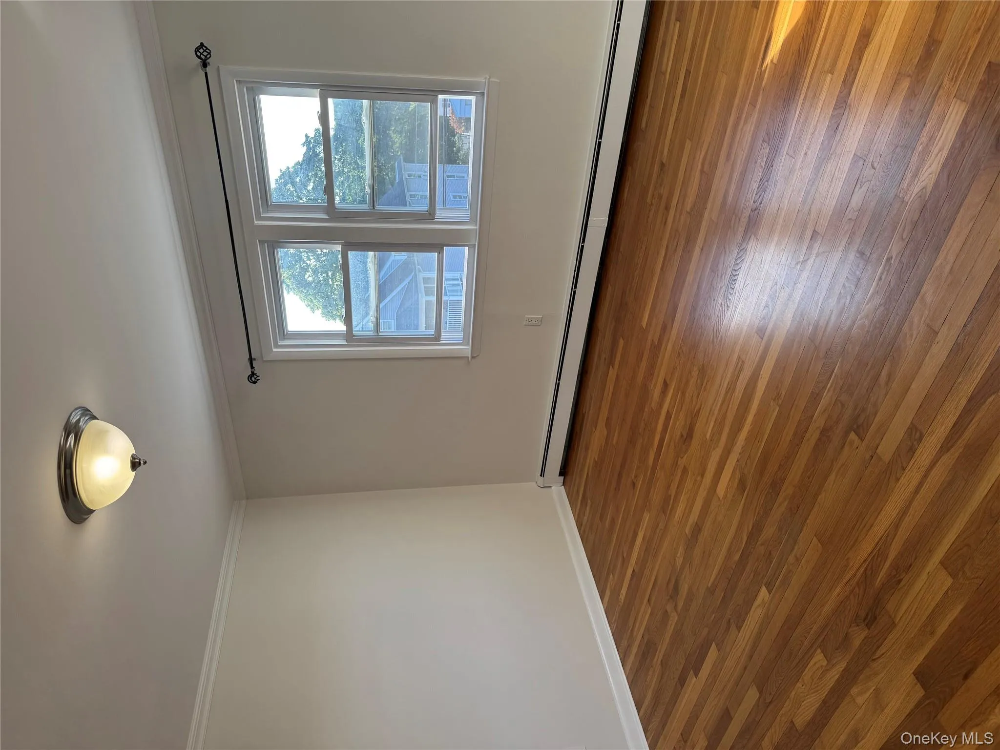 Unfurnished room featuring a baseboard radiator, dark wood-type flooring, and ornamental molding Unfurnished room featuring a baseboard radiator, dark wood-type flooring, and ornamental molding