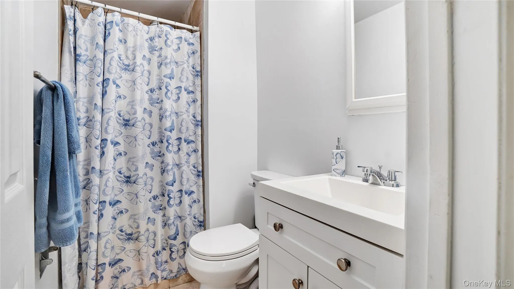 Full bath featuring vanity and a shower with shower curtain Full bath featuring vanity and a shower with shower curtain