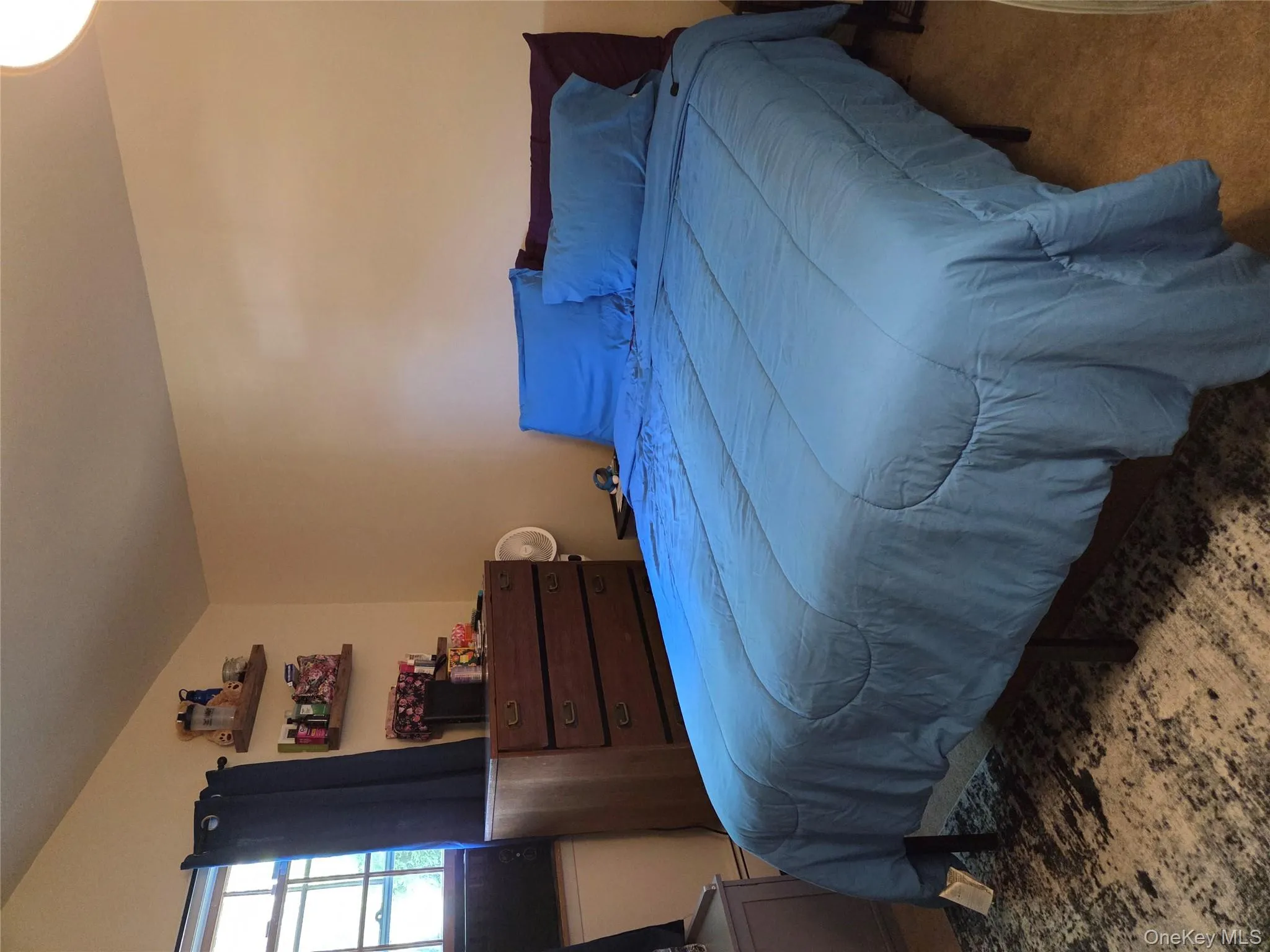 Bedroom with carpet flooring and vaulted ceiling Bedroom with carpet flooring and vaulted ceiling