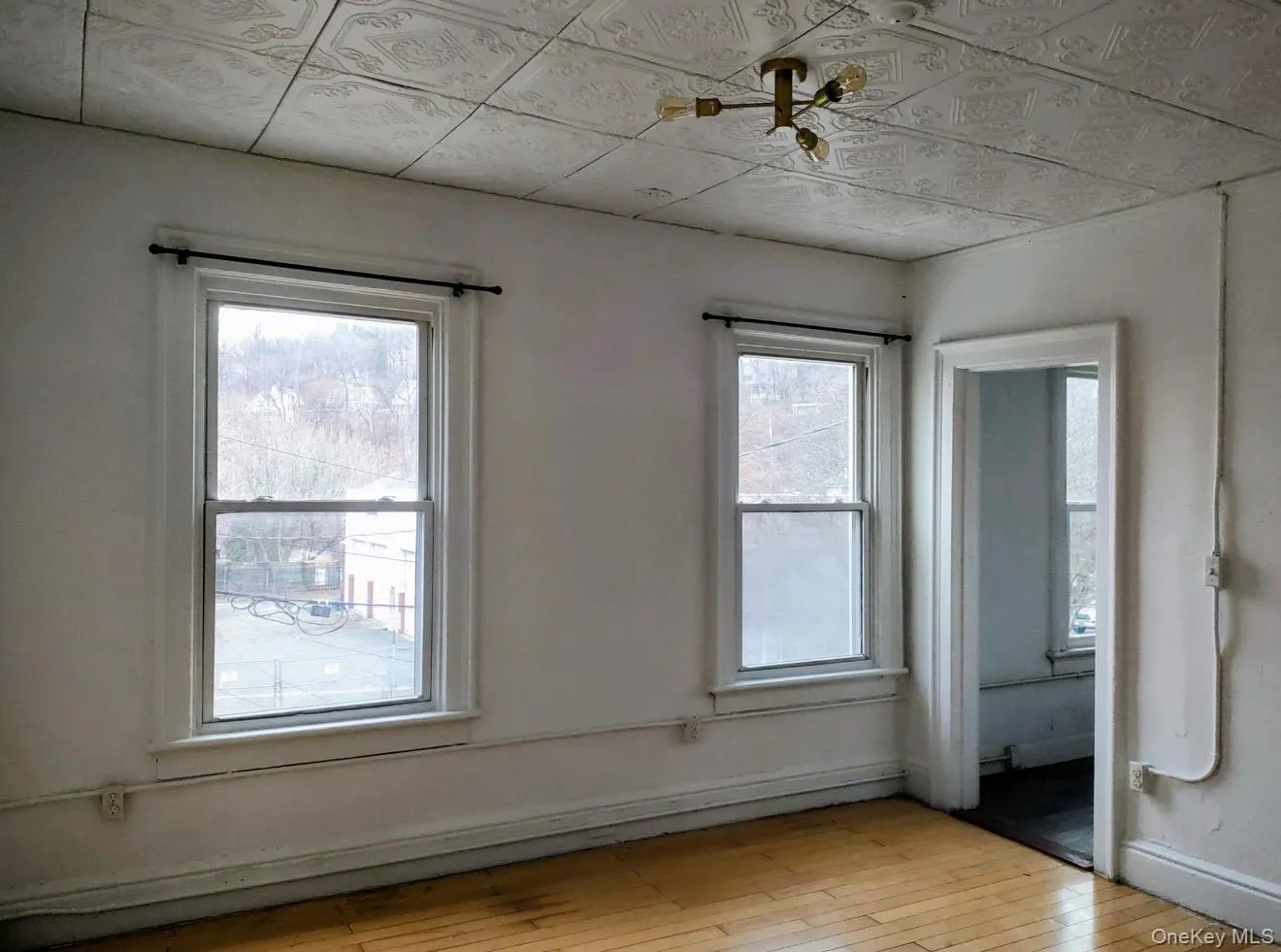 Spare room with light wood-style floors and baseboards Spare room with light wood-style floors and baseboards