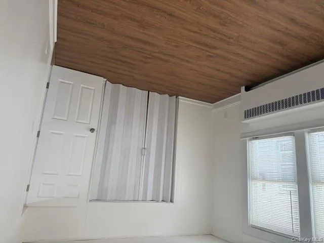 Unfurnished bedroom with dark wood-style floors Unfurnished bedroom with dark wood-style floors