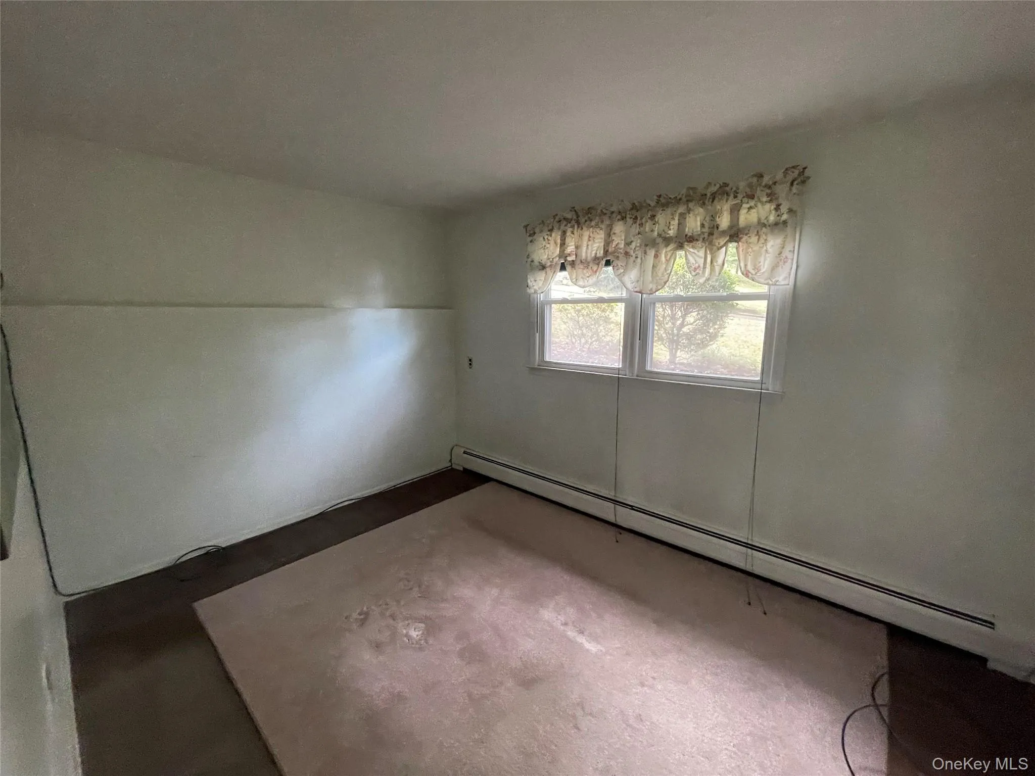 Unfurnished dining area featuring a baseboard radiator Unfurnished dining area featuring a baseboard radiator