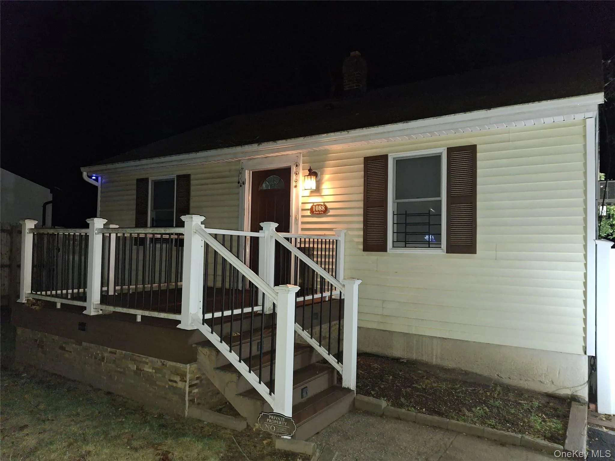 Exterior entry at twilight with a porch Exterior entry at twilight with a porch