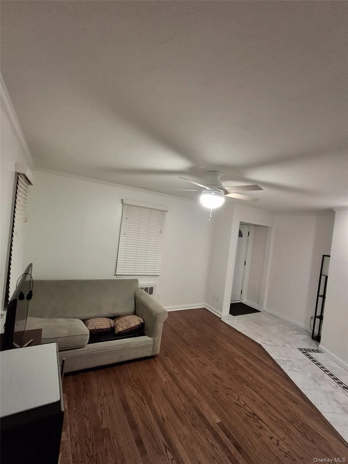 Living area featuring baseboards and dark wood-style floors Living area featuring baseboards and dark wood-style floors