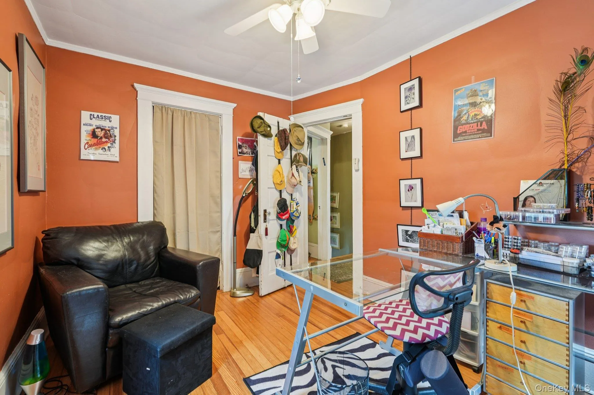 Home office with light wood finished floors, crown molding, and a ceiling fan Home office with light wood finished floors, crown molding, and a ceiling fan
