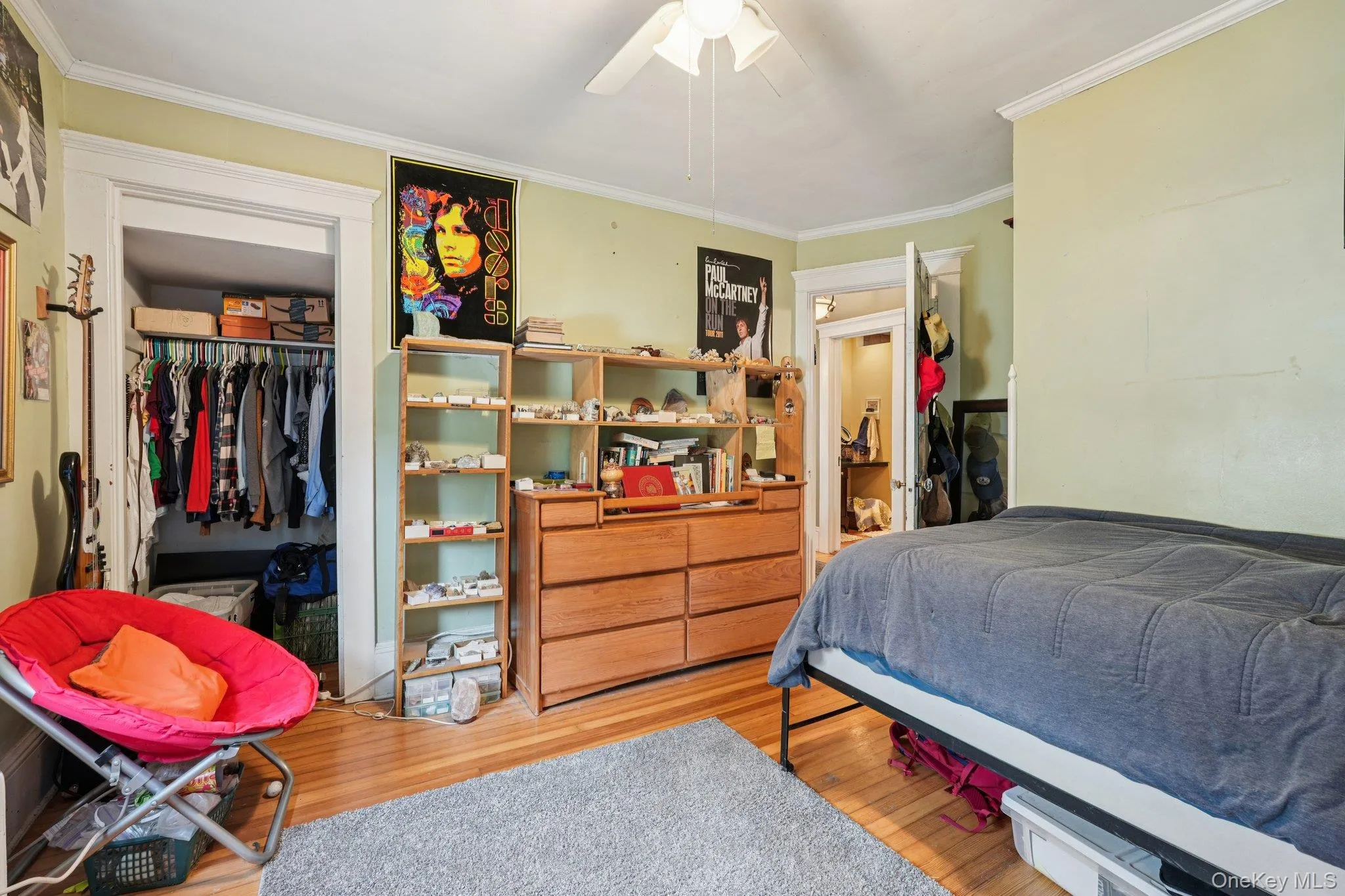 Bedroom with light wood-type flooring, crown molding, a closet, and a ceiling fan Bedroom with light wood-type flooring, crown molding, a closet, and a ceiling fan