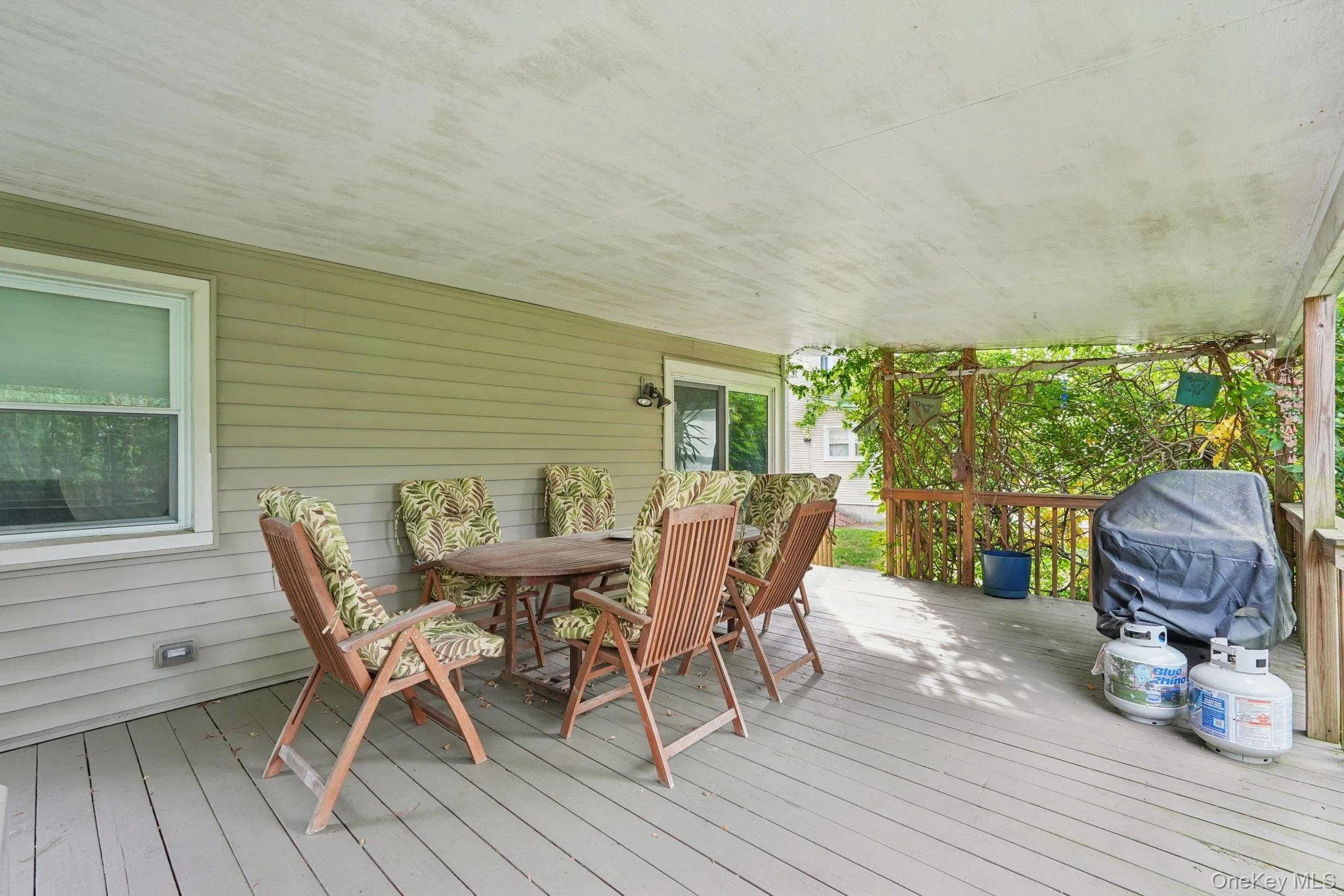 Wooden terrace with outdoor dining area and area for grilling Wooden terrace with outdoor dining area and area for grilling