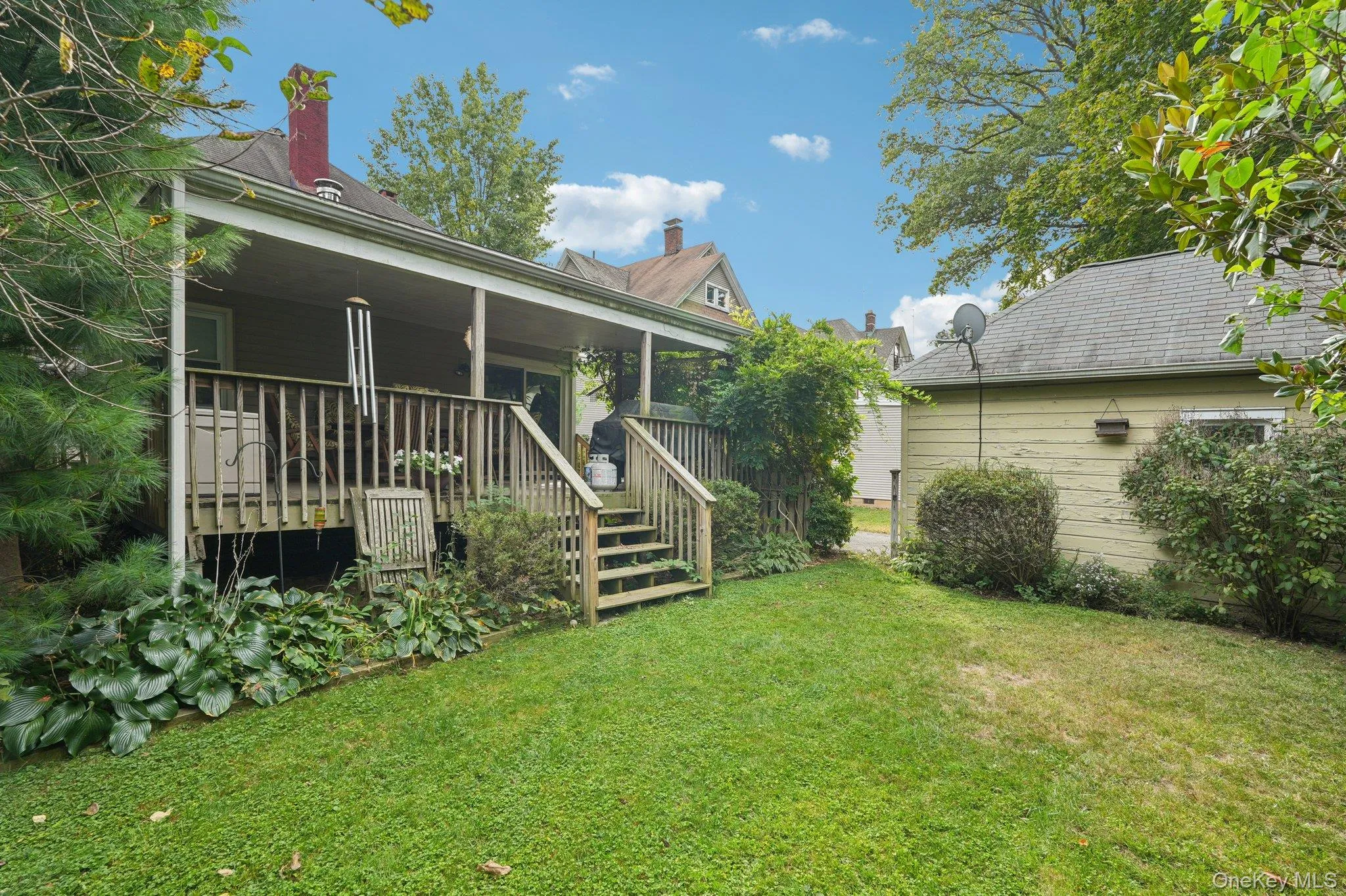 Rear view of property featuring a porch and a yard Rear view of property featuring a porch and a yard