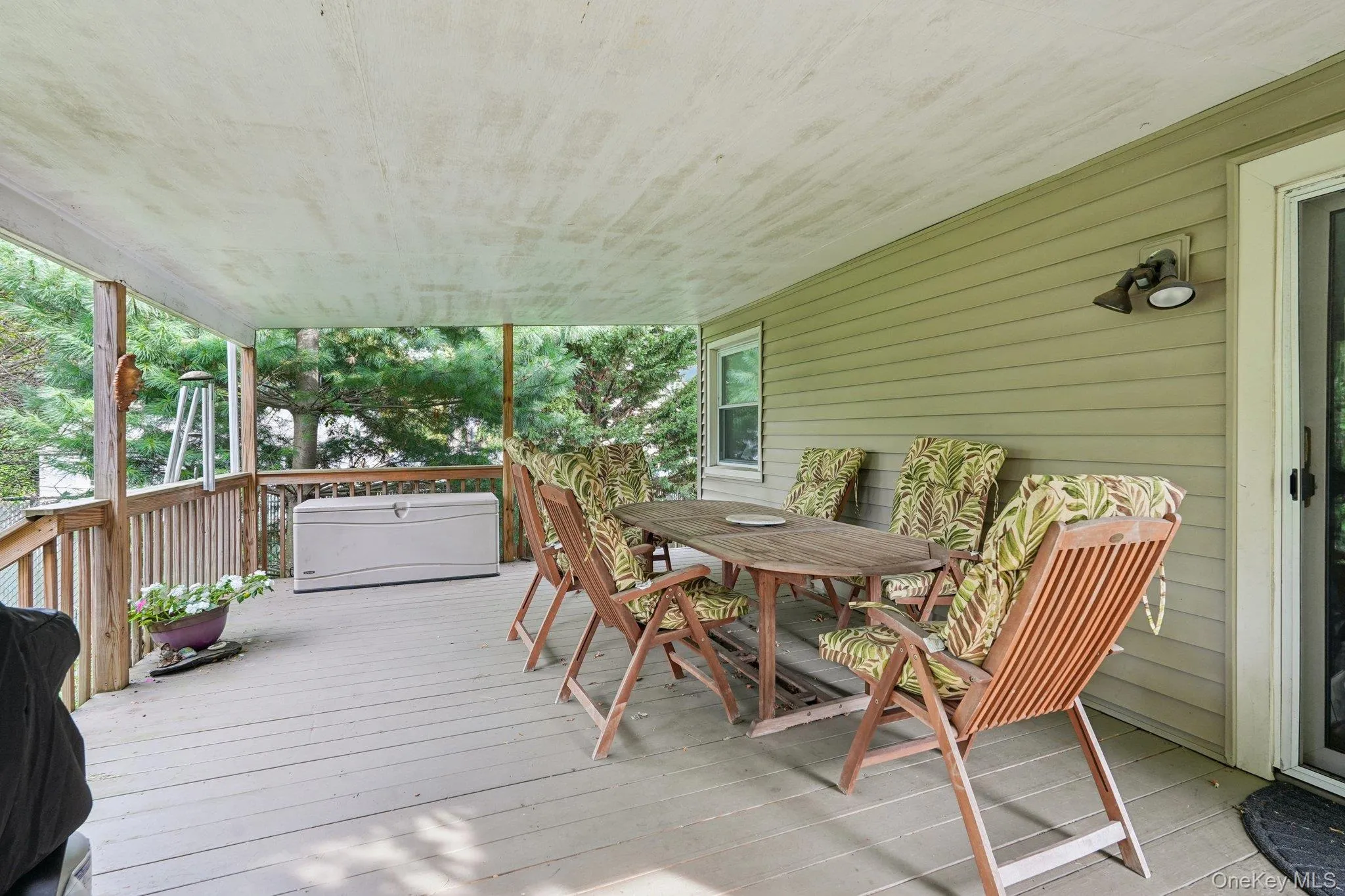 Wooden deck featuring outdoor dining area Wooden deck featuring outdoor dining area