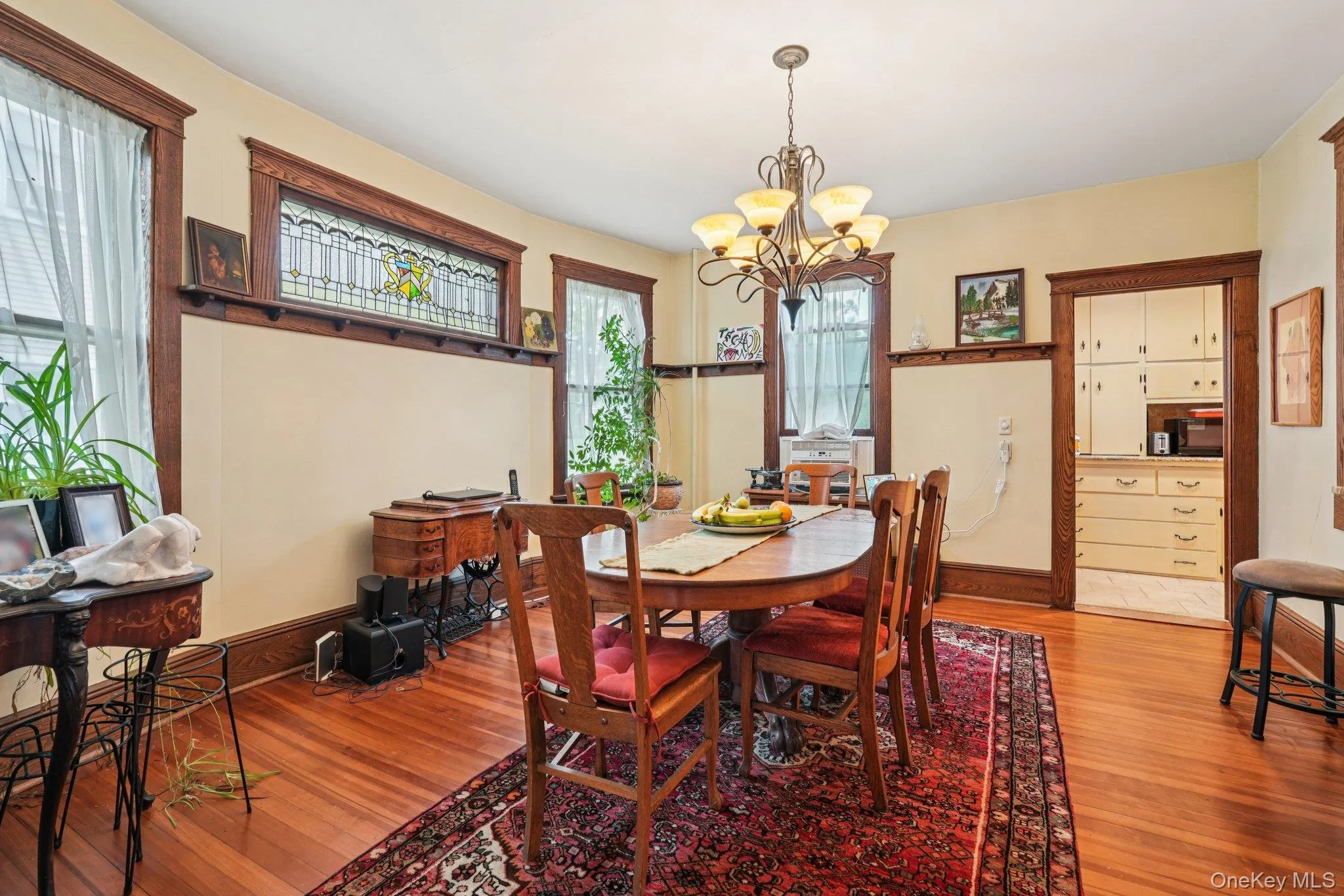 Dining space with light wood-type flooring and a chandelier Dining space with light wood-type flooring and a chandelier