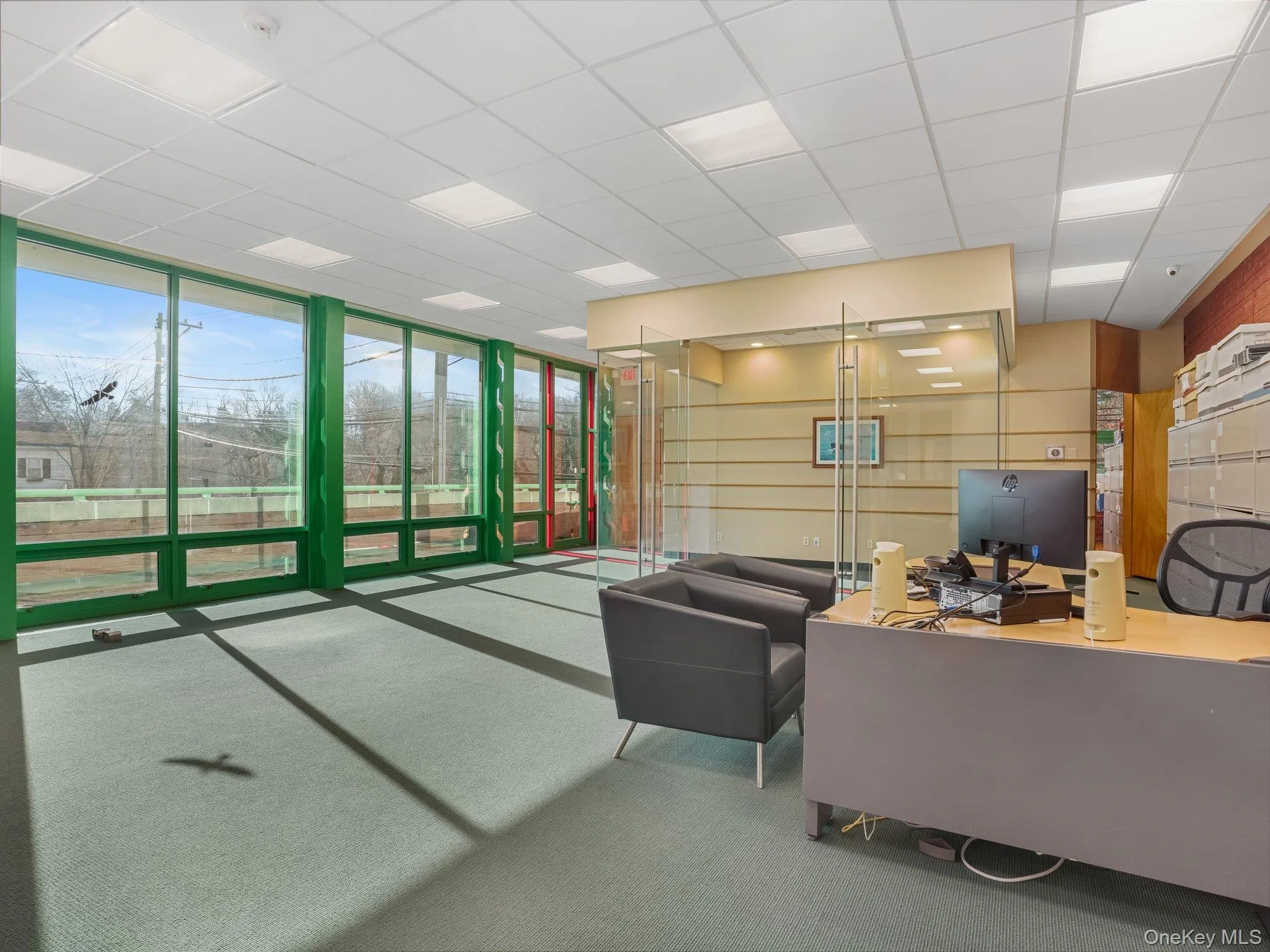 Community lobby featuring a drop ceiling and a wall of windows Community lobby featuring a drop ceiling and a wall of windows