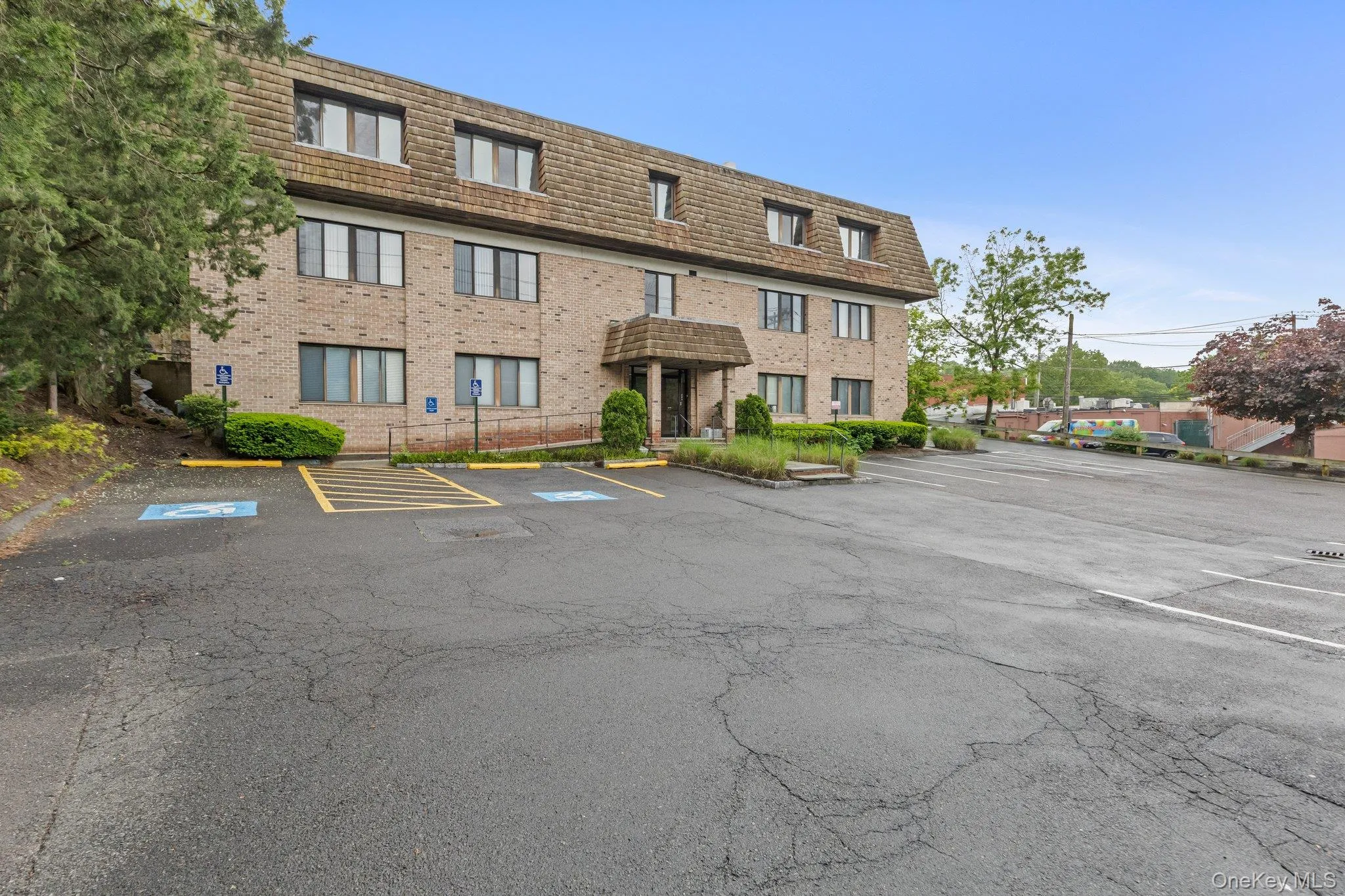 View of property featuring uncovered parking View of property featuring uncovered parking