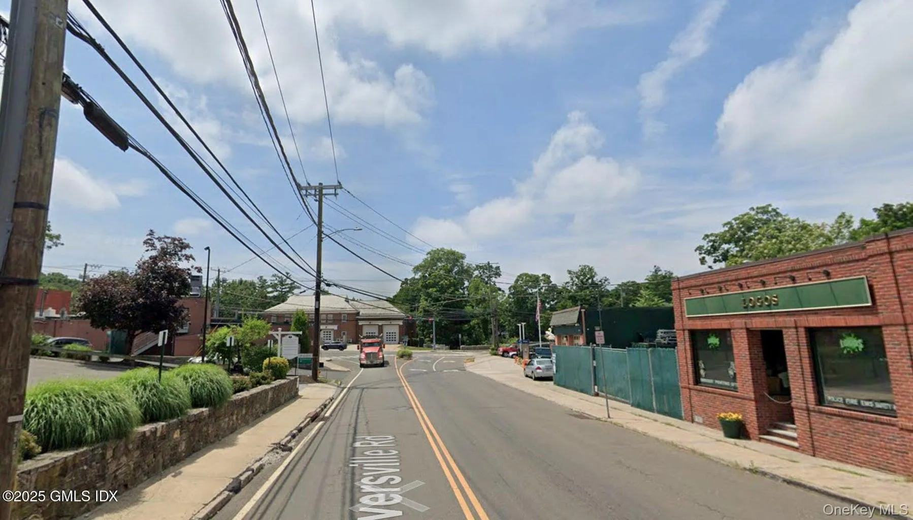 View of asphalt street with sidewalks, curbs, and street lights View of asphalt street with sidewalks, curbs, and street lights