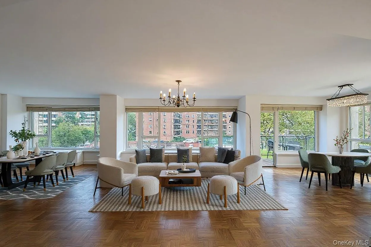 Living room featuring a chandelier and plenty of natural light Living room featuring a chandelier and plenty of natural light