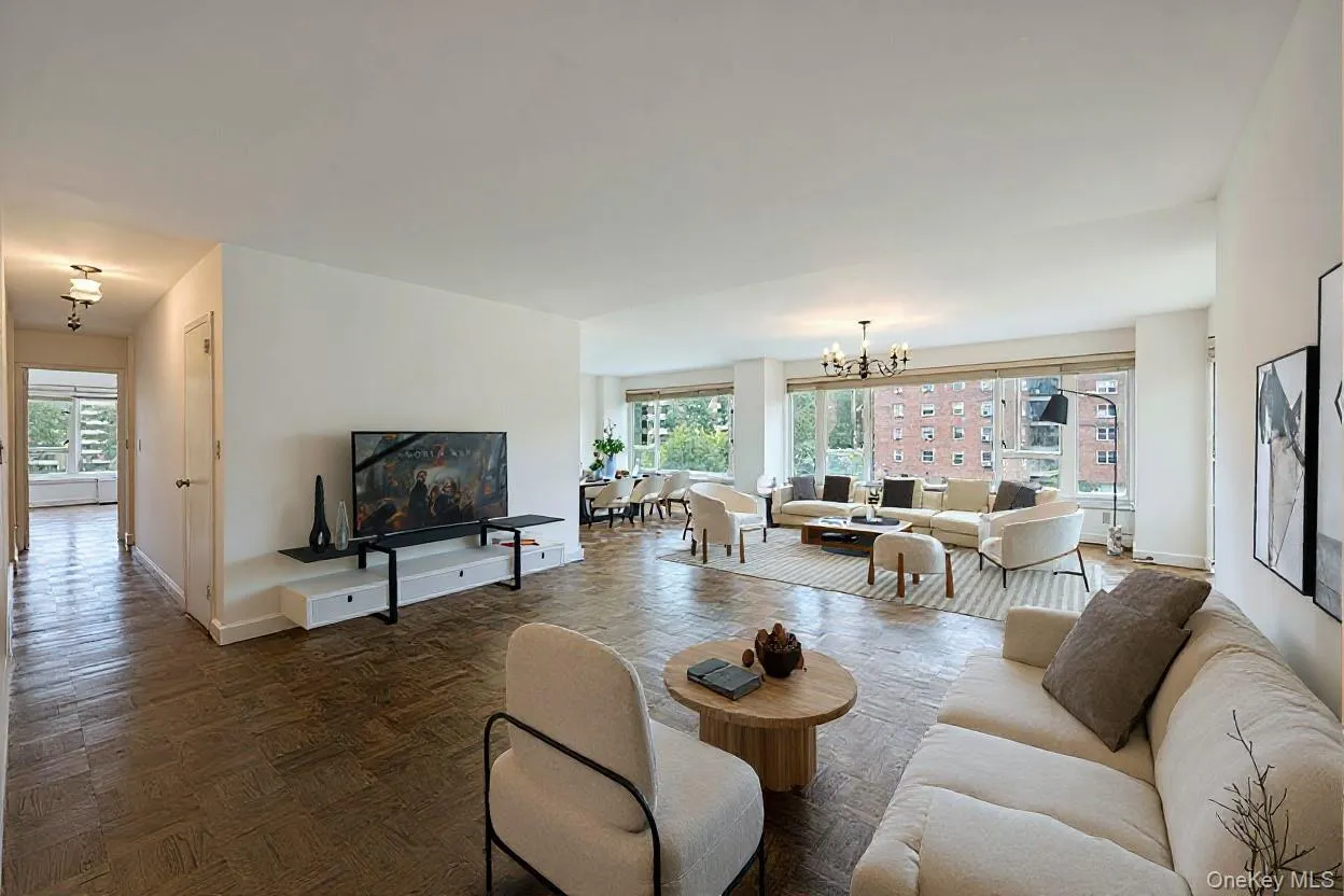 Living area with healthy amount of natural light and a chandelier Living area with healthy amount of natural light and a chandelier