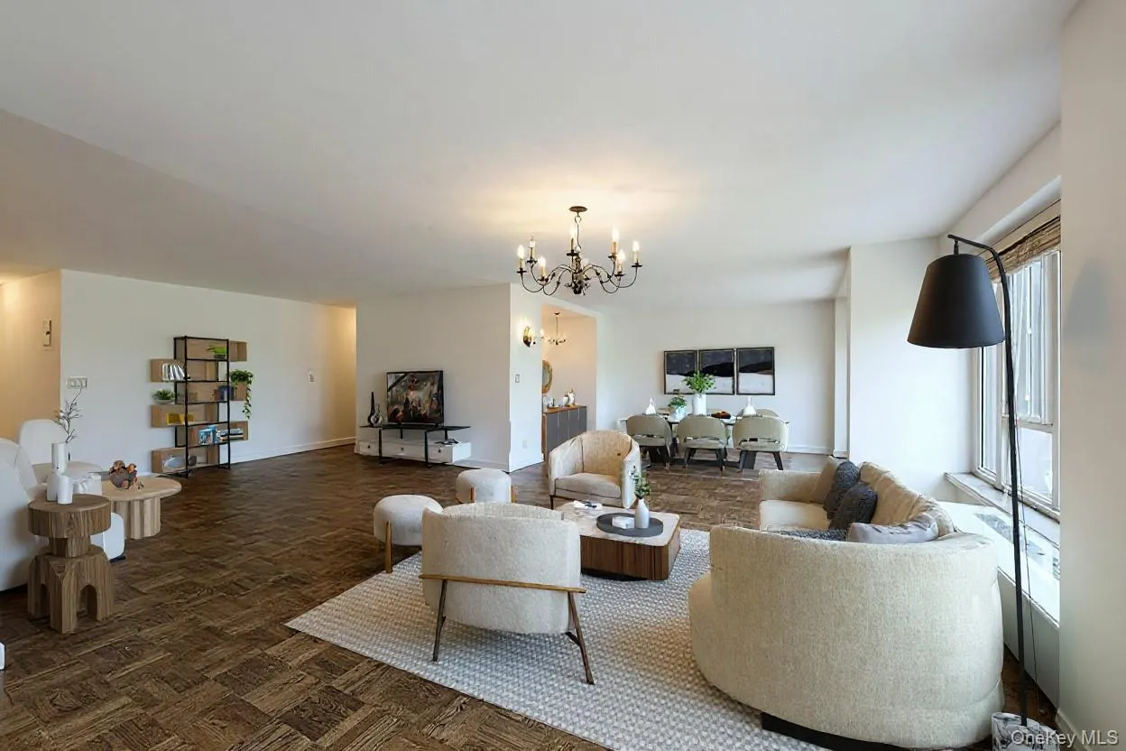 Living area featuring a chandelier and baseboards Living area featuring a chandelier and baseboards