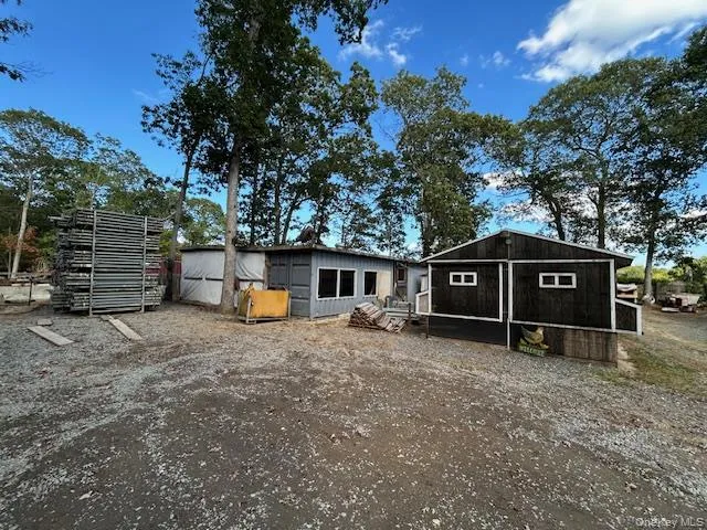 Rear view of property featuring a outdoor structures Rear view of property featuring a outdoor structures