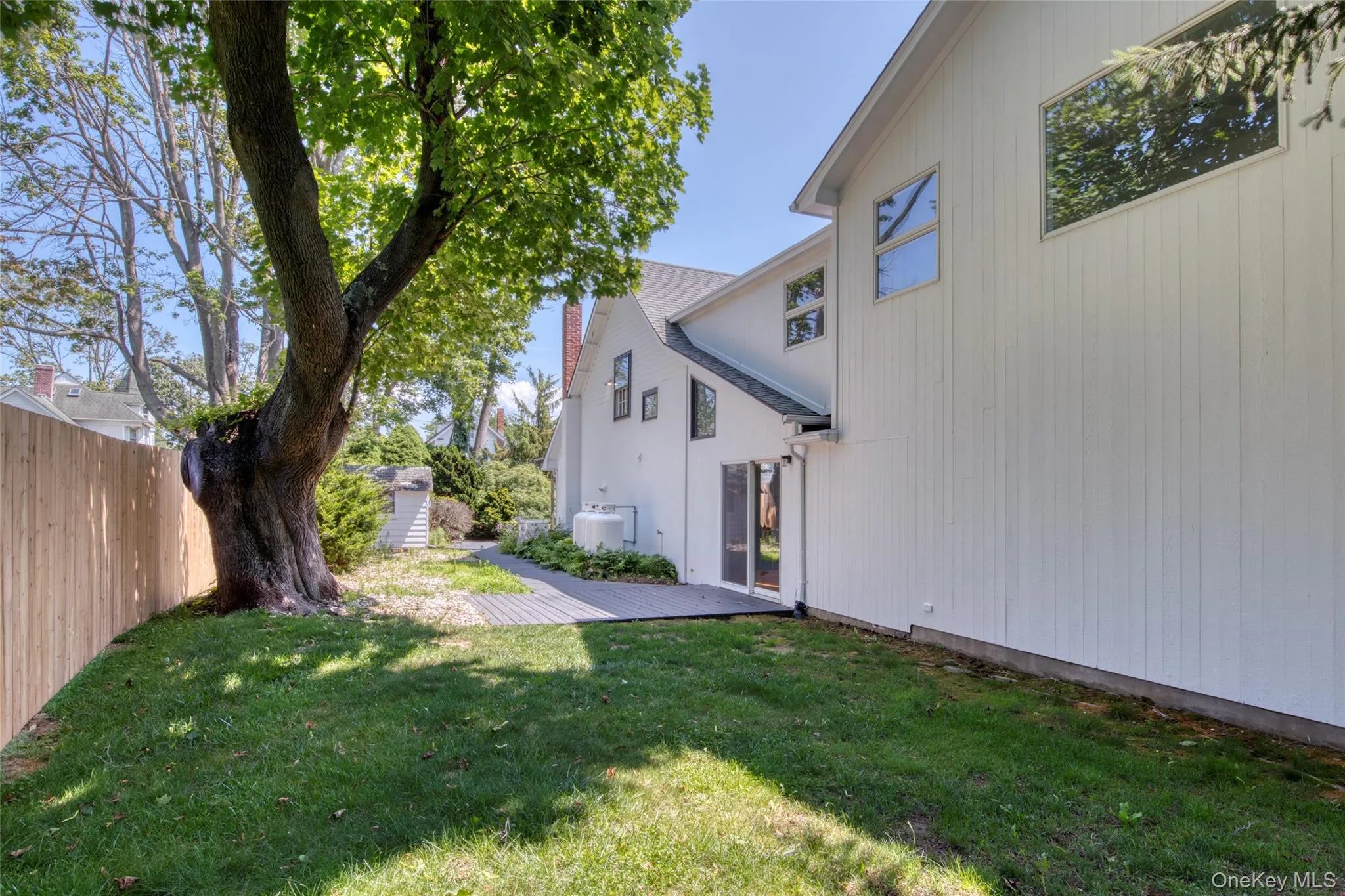 View of yard featuring a wooden deck and a shed View of yard featuring a wooden deck and a shed