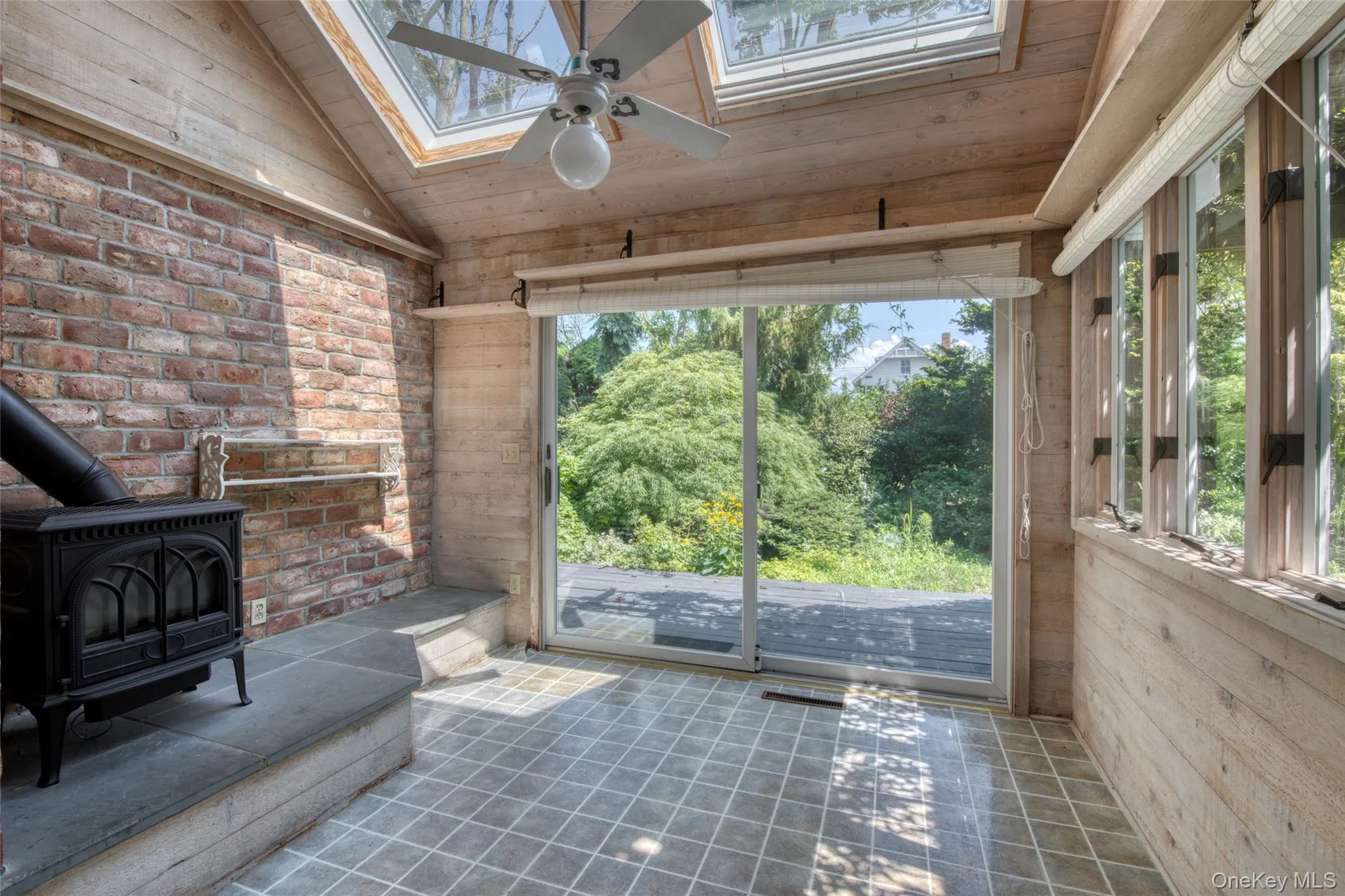 View of patio / terrace featuring ceiling fan and a sunroom View of patio / terrace featuring ceiling fan and a sunroom