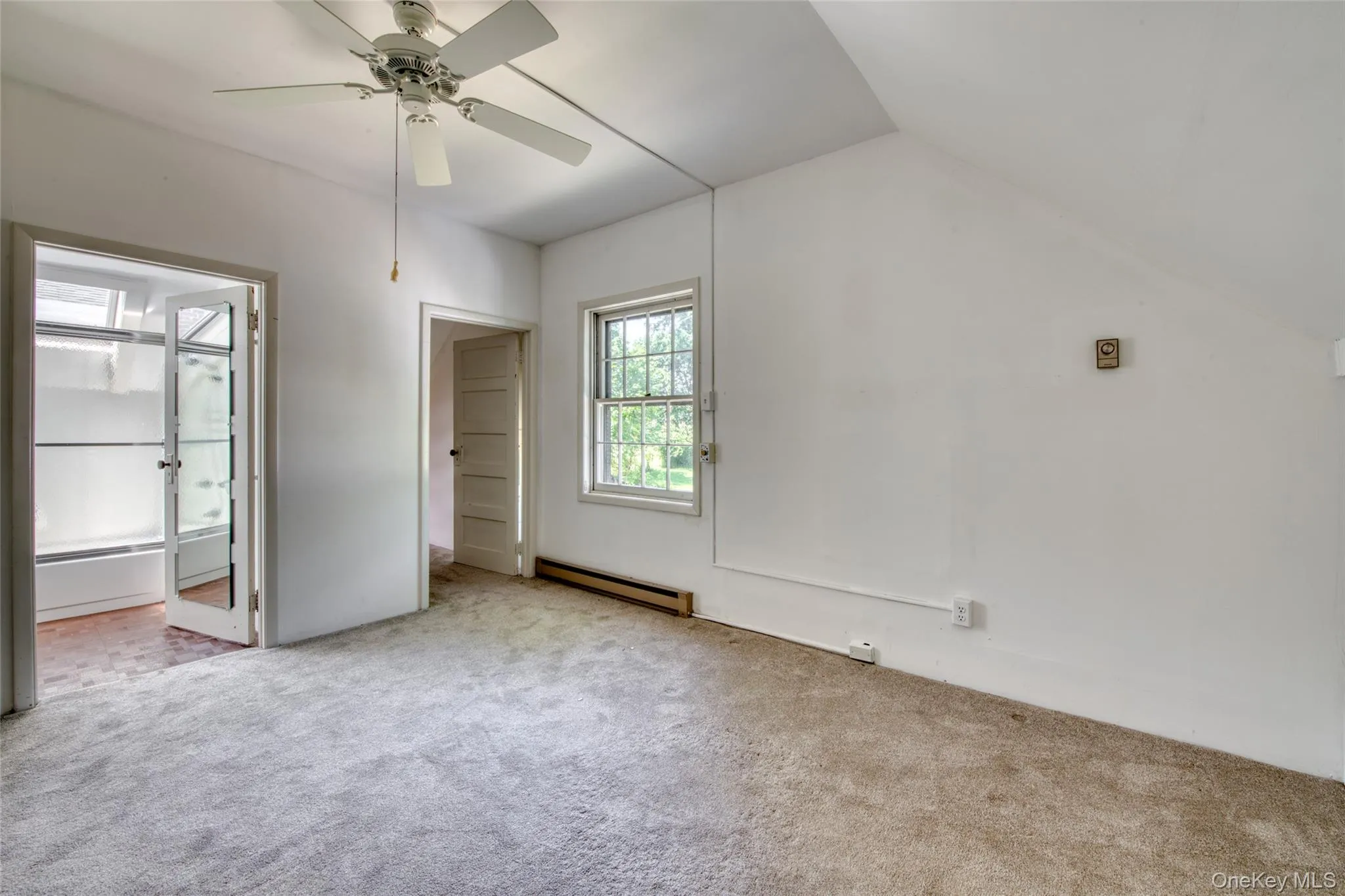 Unfurnished bedroom with baseboard heating, carpet floors, and ceiling fan Unfurnished bedroom with baseboard heating, carpet floors, and ceiling fan
