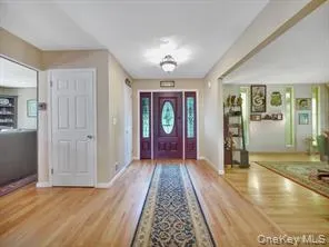 Foyer with baseboards and light wood finished floors Foyer with baseboards and light wood finished floors