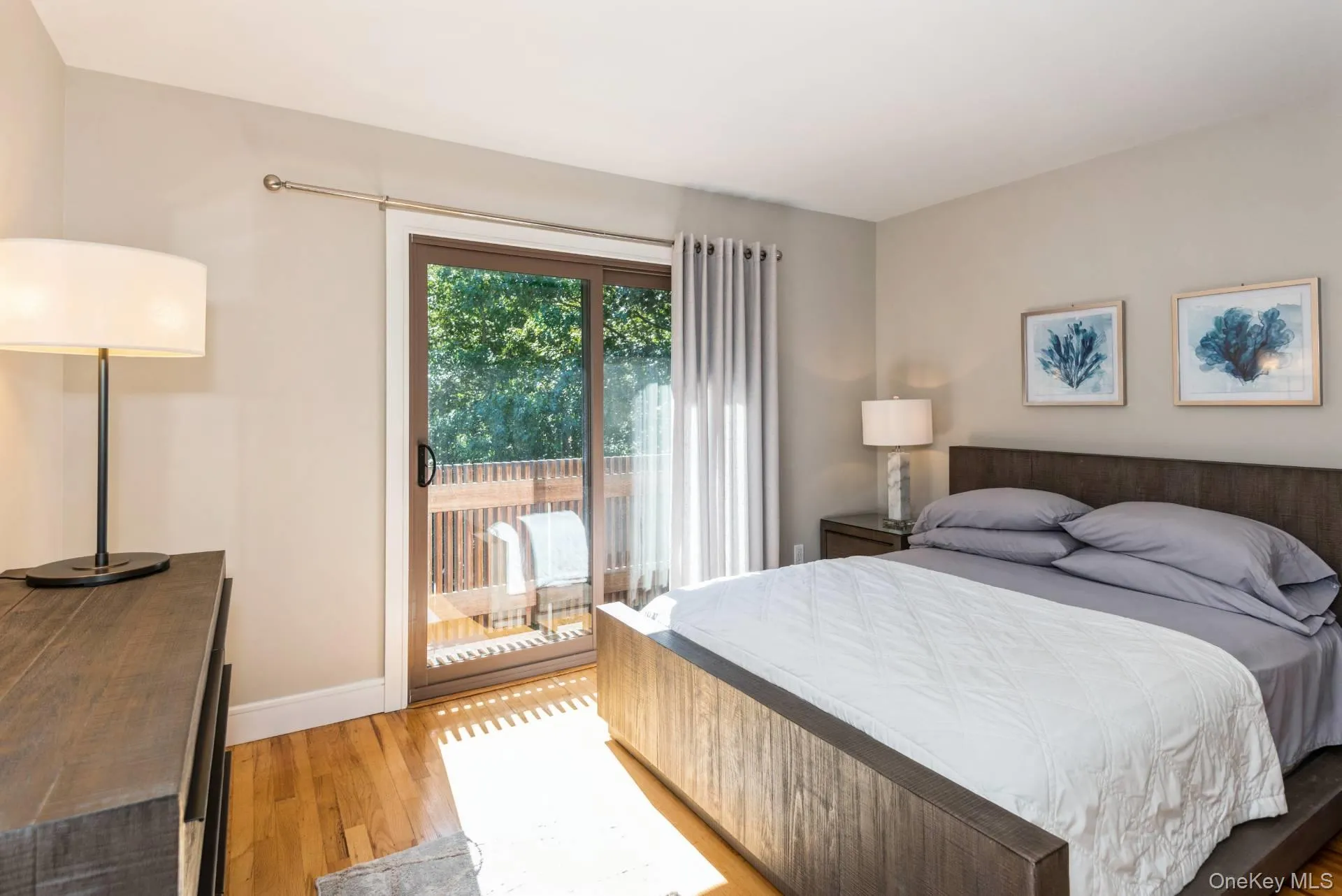 Bedroom with wood finished floors and access to outside Bedroom with wood finished floors and access to outside