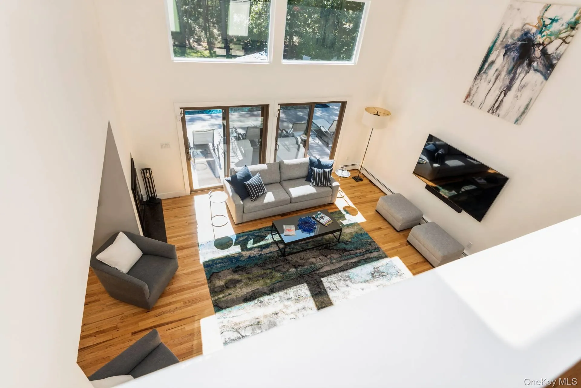 Living room with light wood finished floors and a high ceiling Living room with light wood finished floors and a high ceiling