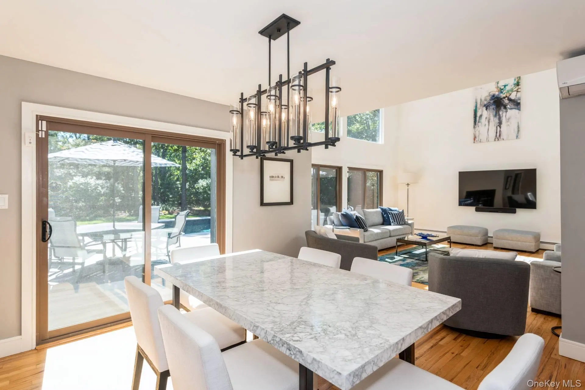 Dining area featuring light wood-type flooring and a wall unit AC Dining area featuring light wood-type flooring and a wall unit AC