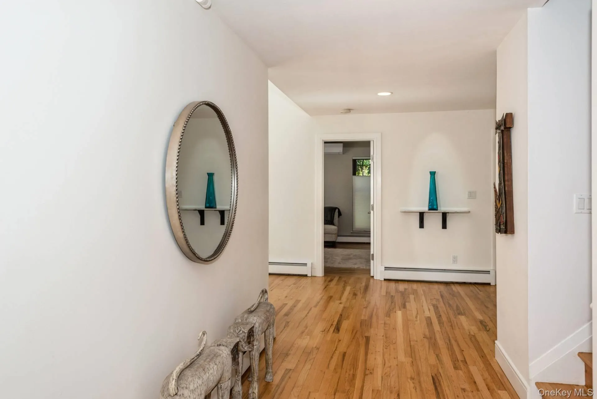 Hall with light wood-style flooring, a baseboard radiator, and recessed lighting Hall with light wood-style flooring, a baseboard radiator, and recessed lighting