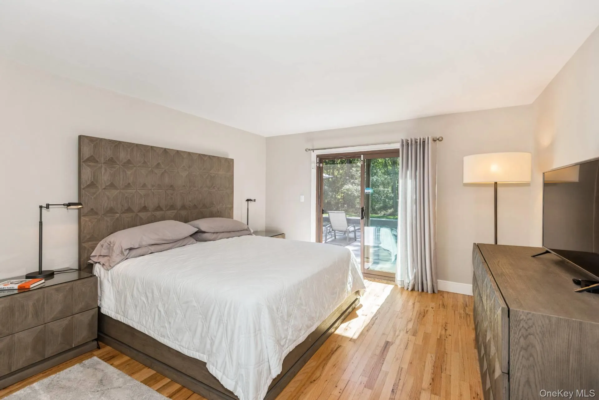 Bedroom with light wood-style flooring and access to outside Bedroom with light wood-style flooring and access to outside