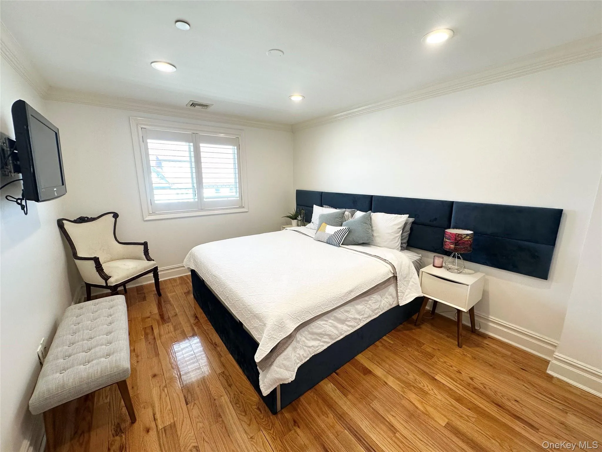 Bedroom featuring wood finished floors, ornamental molding, and recessed lighting Bedroom featuring wood finished floors, ornamental molding, and recessed lighting