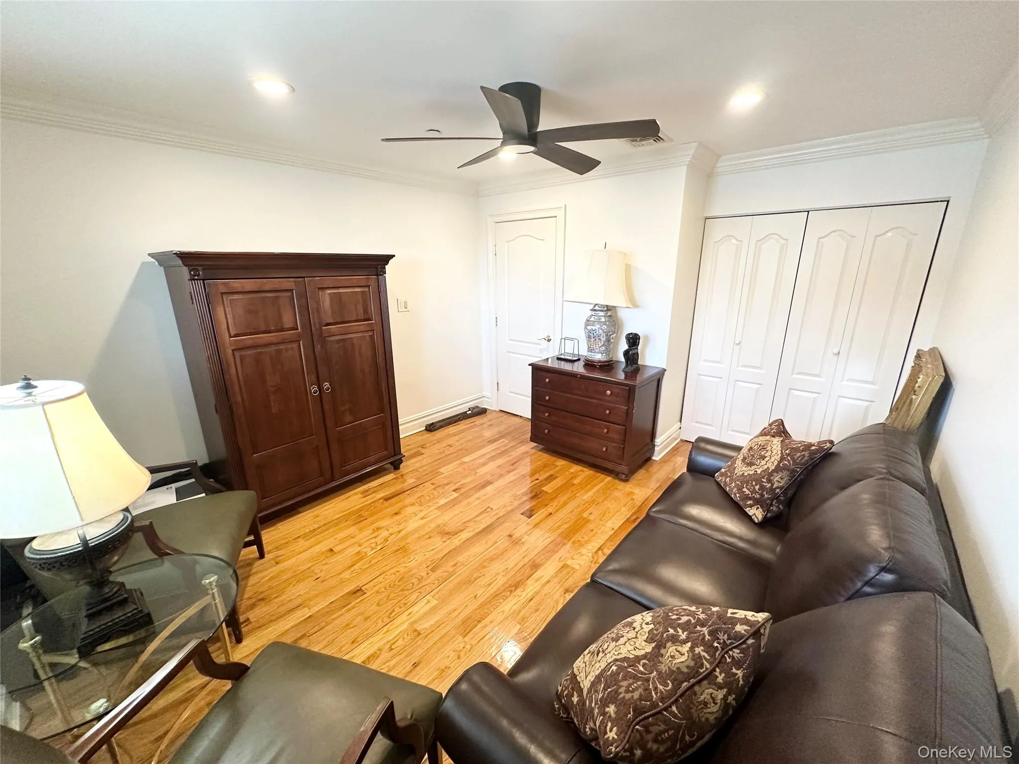 Living room with crown molding, light wood-type flooring, ceiling fan, and recessed lighting Living room with crown molding, light wood-type flooring, ceiling fan, and recessed lighting