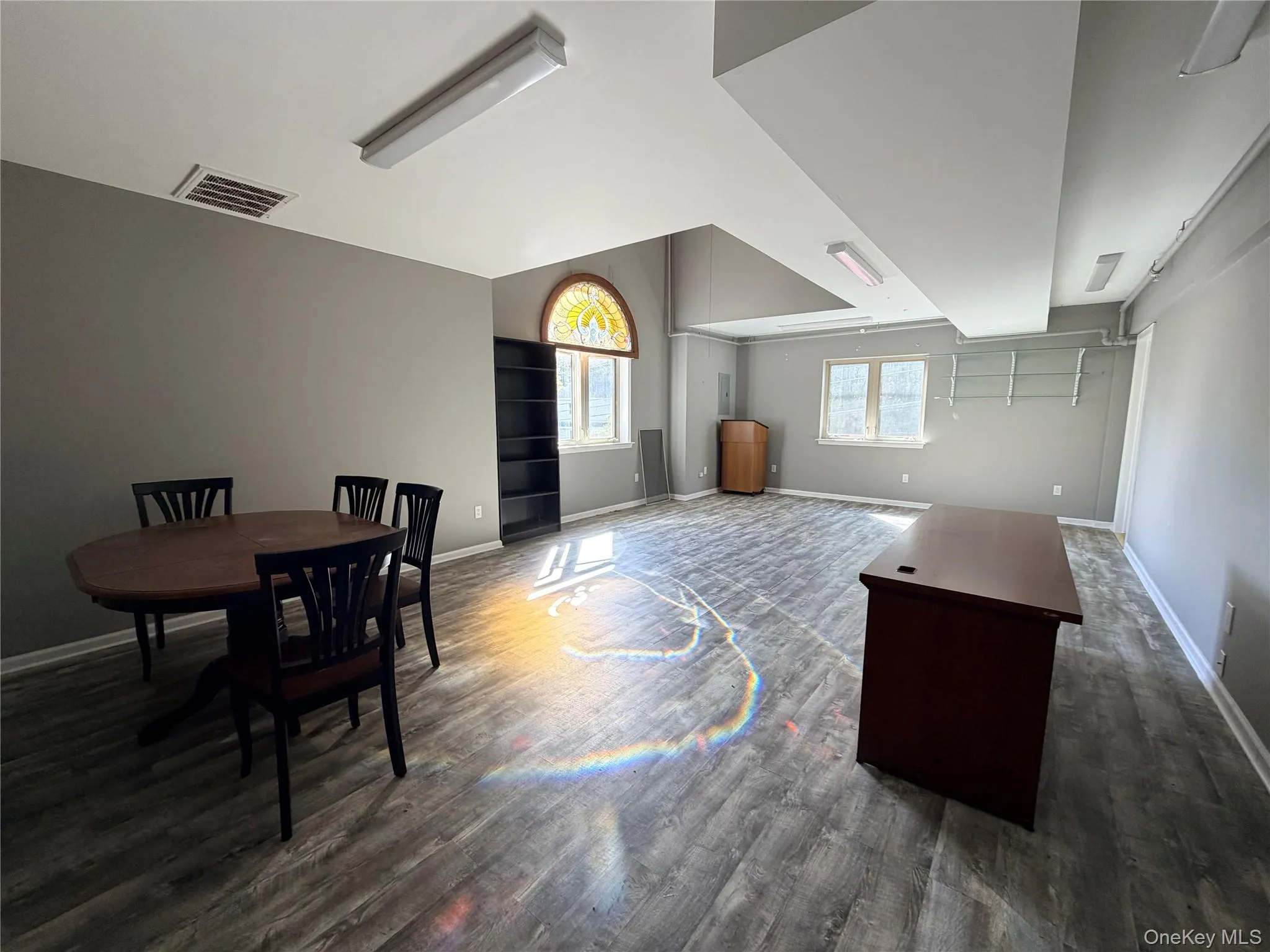 Bonus room with baseboards and dark wood-type flooring Bonus room with baseboards and dark wood-type flooring