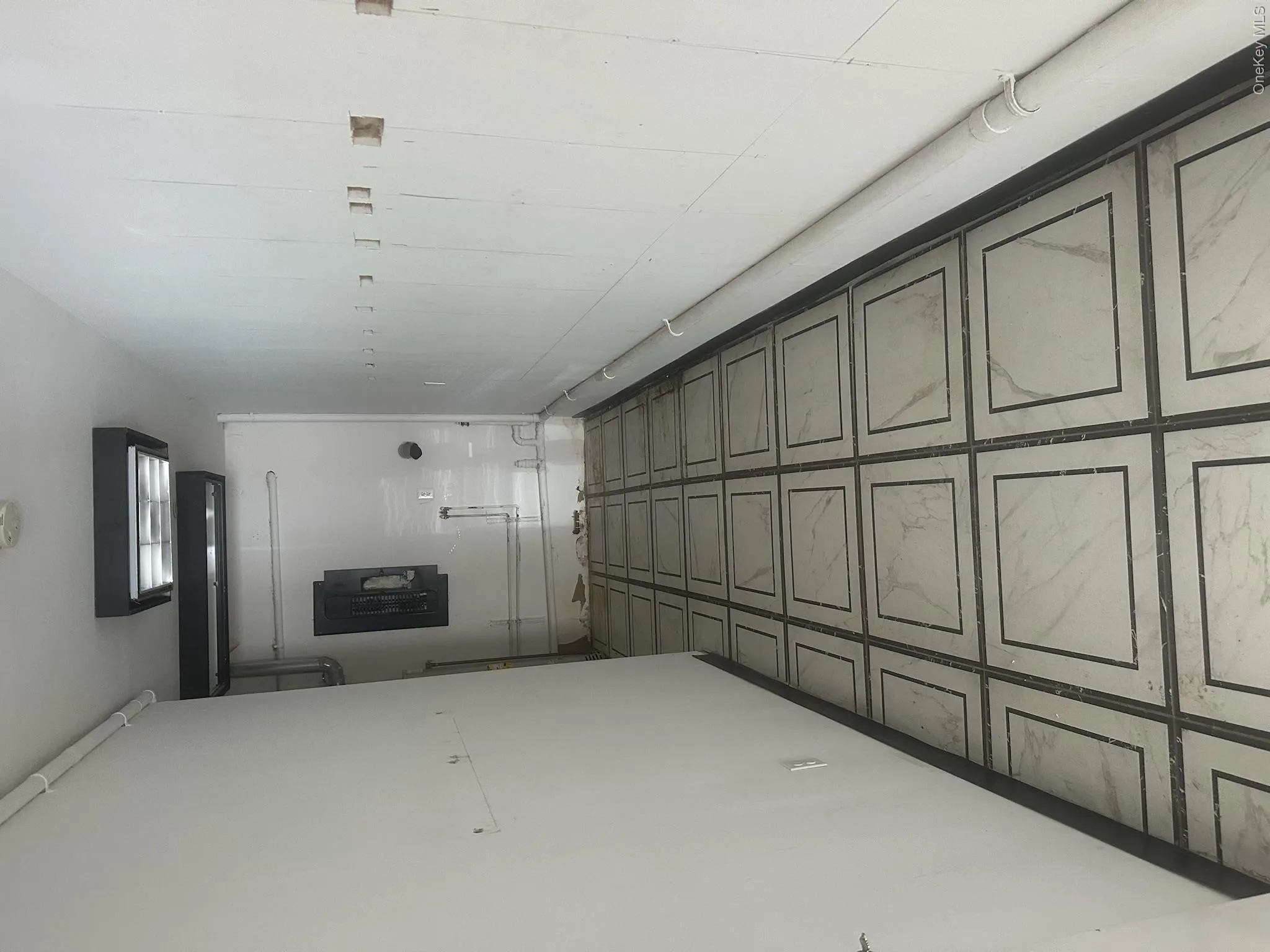 Corridor featuring baseboards and electric panel Corridor featuring baseboards and electric panel