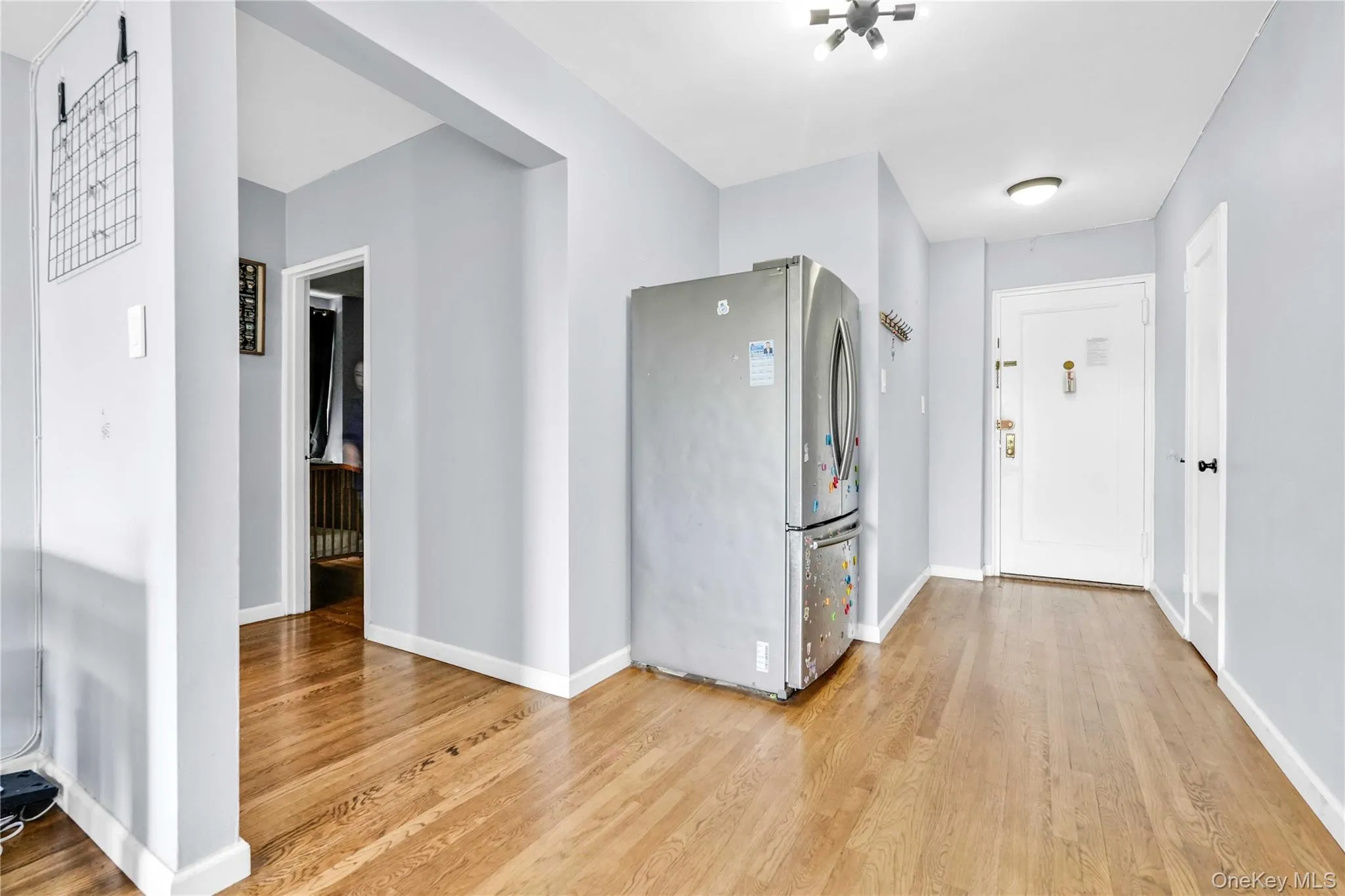 Kitchen with freestanding refrigerator and light wood finished floors Kitchen with freestanding refrigerator and light wood finished floors