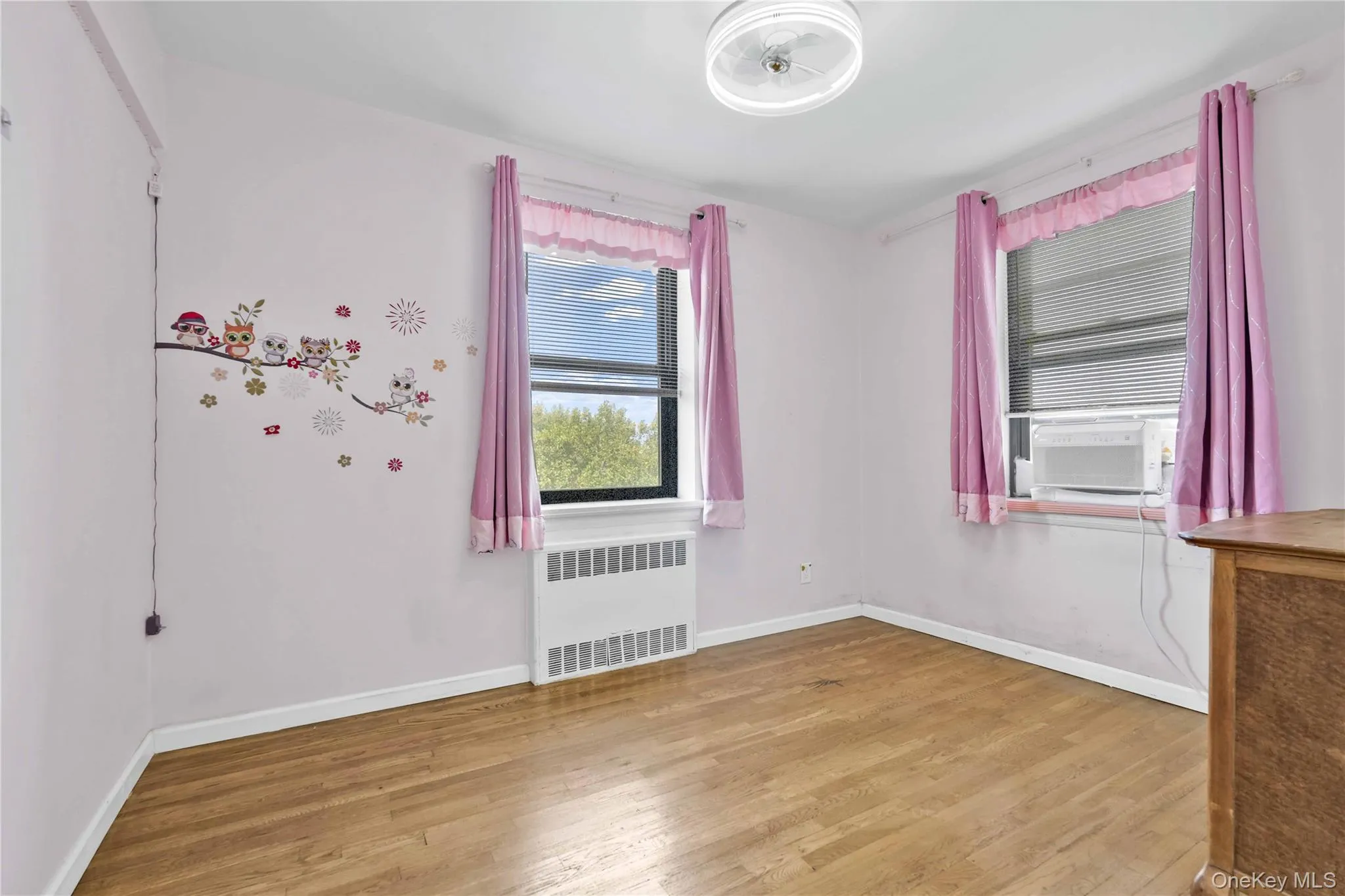 Unfurnished room with radiator and light wood-type flooring Unfurnished room with radiator and light wood-type flooring