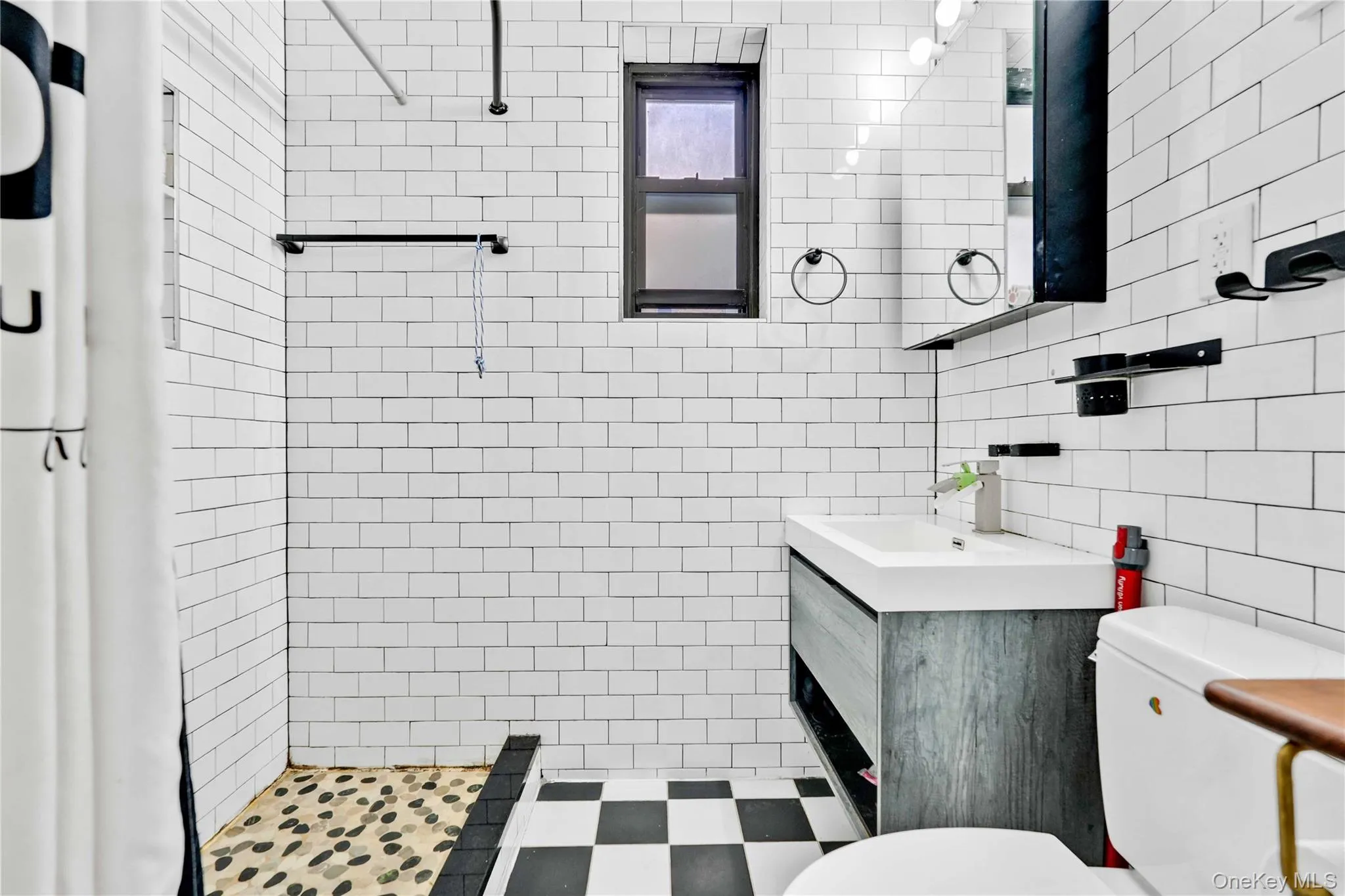 Full bathroom featuring vanity, a shower stall, and tile walls Full bathroom featuring vanity, a shower stall, and tile walls