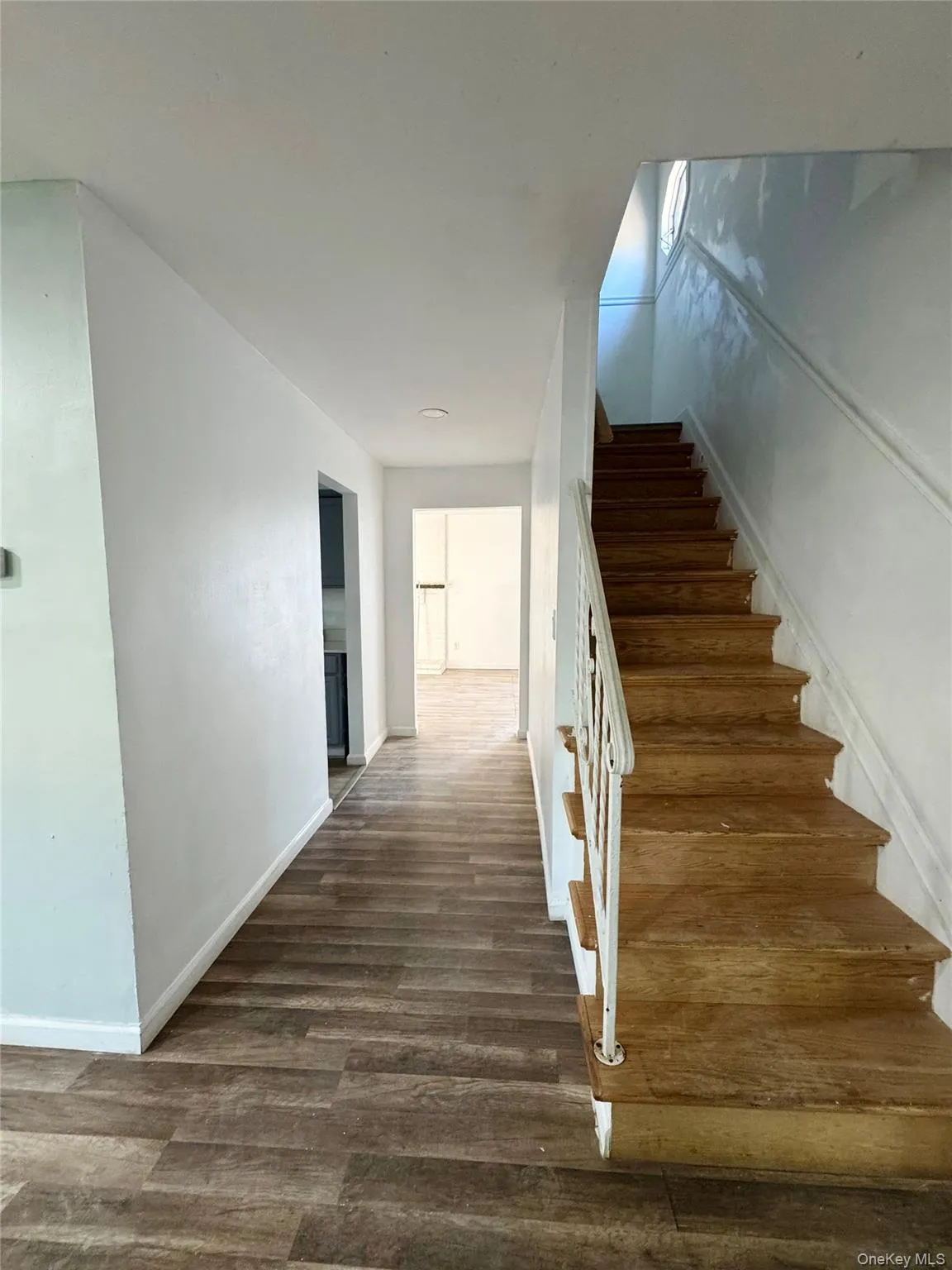 Staircase featuring wood finished floors and baseboards Staircase featuring wood finished floors and baseboards