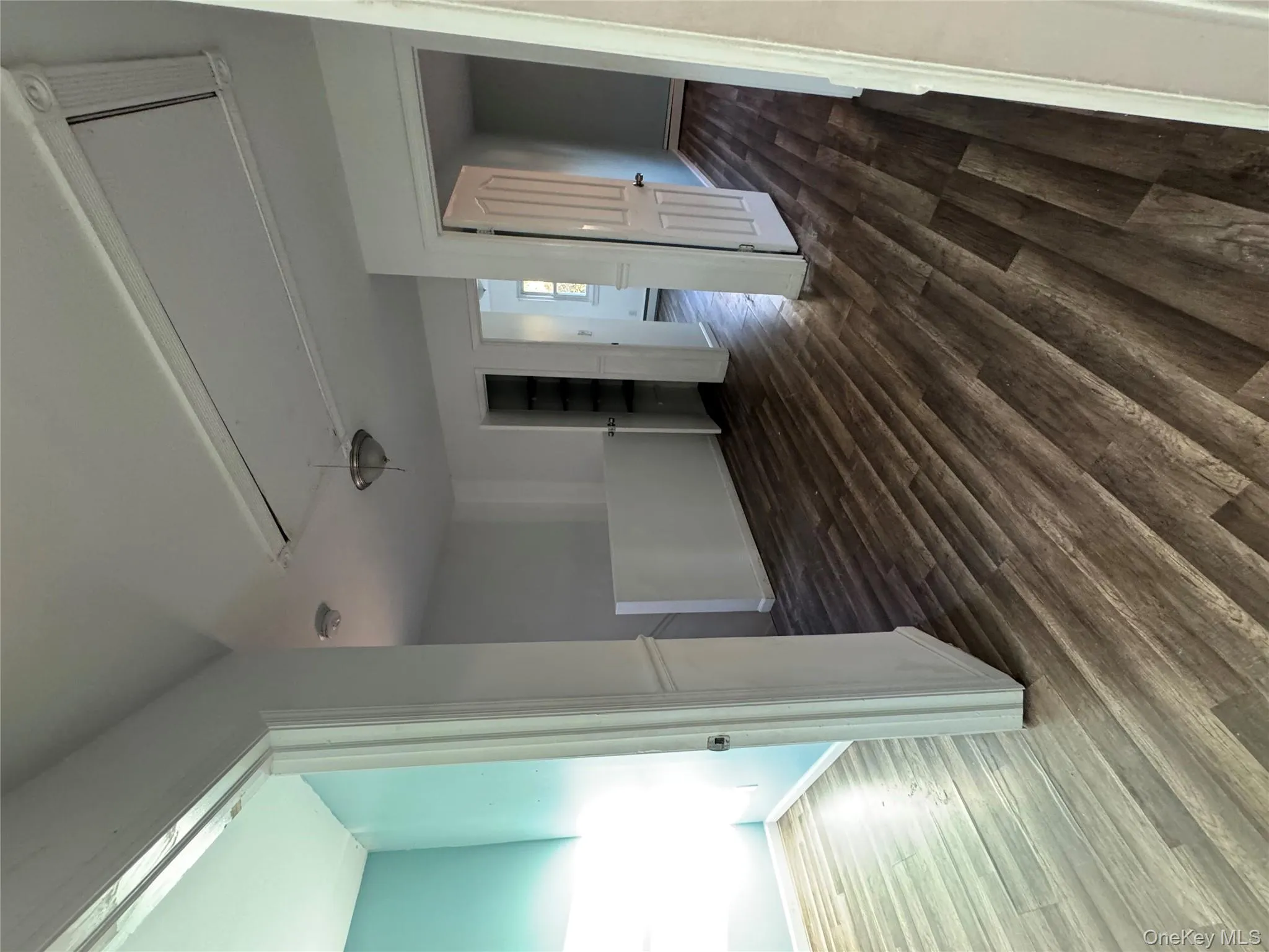 Unfurnished room featuring attic access and dark wood-type flooring Unfurnished room featuring attic access and dark wood-type flooring