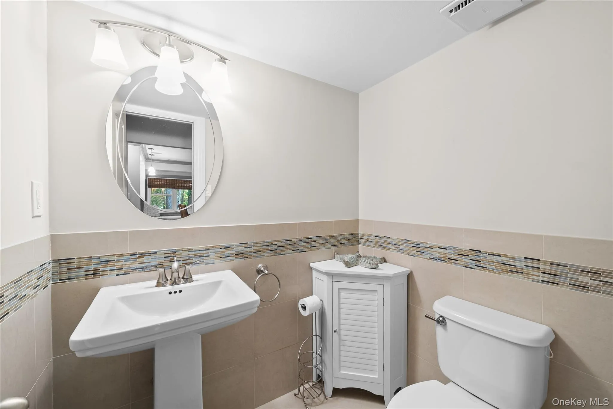Bathroom featuring tile walls and a wainscoted wall Bathroom featuring tile walls and a wainscoted wall