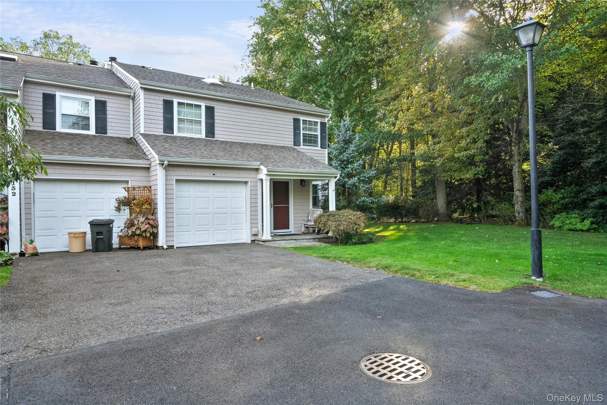 View of front of property with a front lawn, driveway, roof with shingles, and an attached garage View of front of property with a front lawn, driveway, roof with shingles, and an attached garage