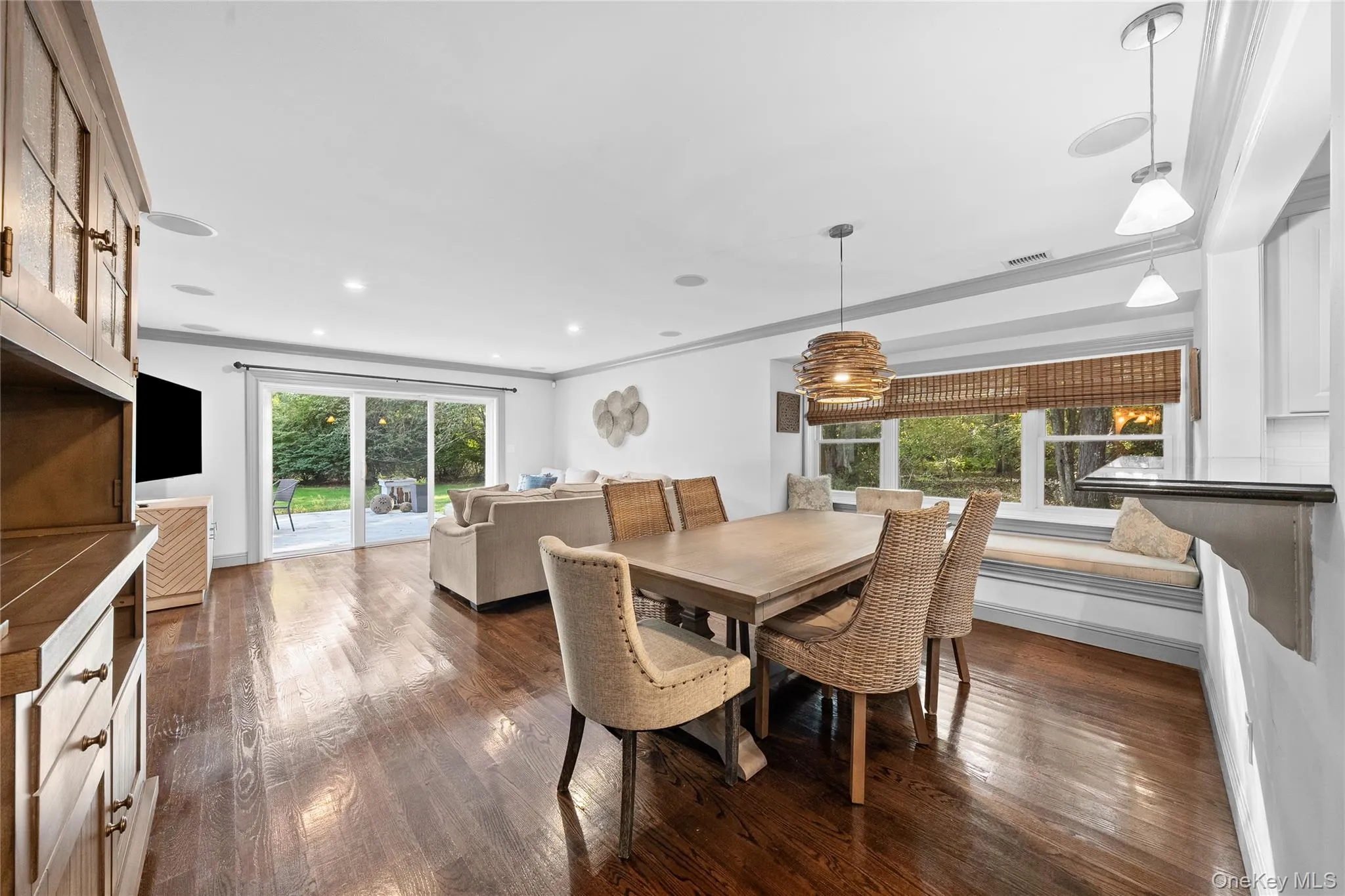Dining room with dark wood-style floors and ornamental molding Dining room with dark wood-style floors and ornamental molding