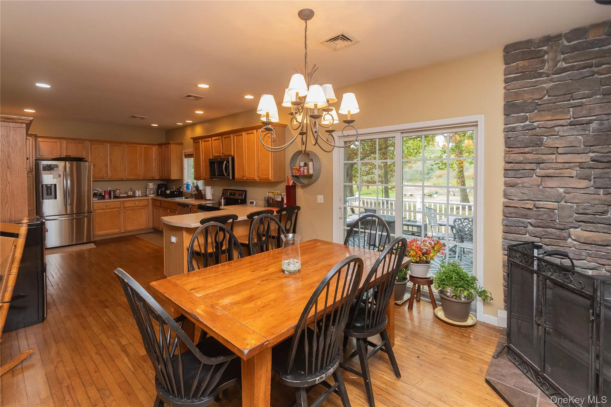 Dining area featuring light wood-style floors, a chandelier, and recessed lighting Dining area featuring light wood-style floors, a chandelier, and recessed lighting