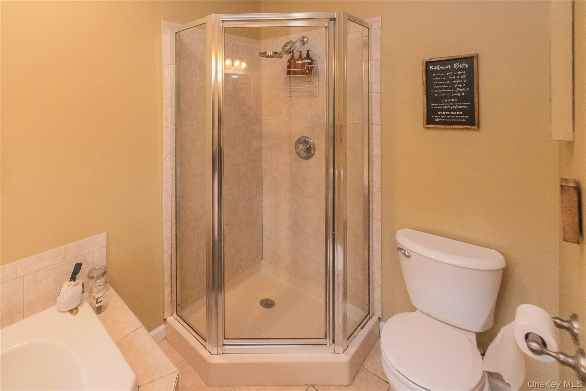 Full bathroom with a shower stall, a garden tub, and tile patterned floors Full bathroom with a shower stall, a garden tub, and tile patterned floors
