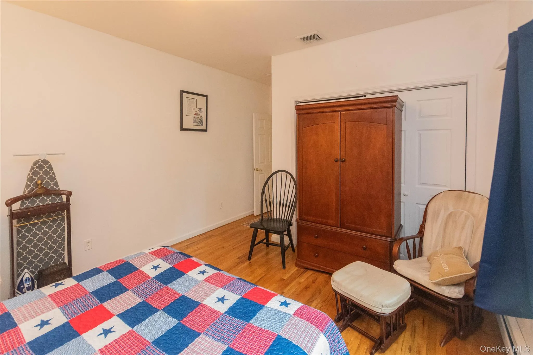 Bedroom featuring light wood-style floors and a closet Bedroom featuring light wood-style floors and a closet