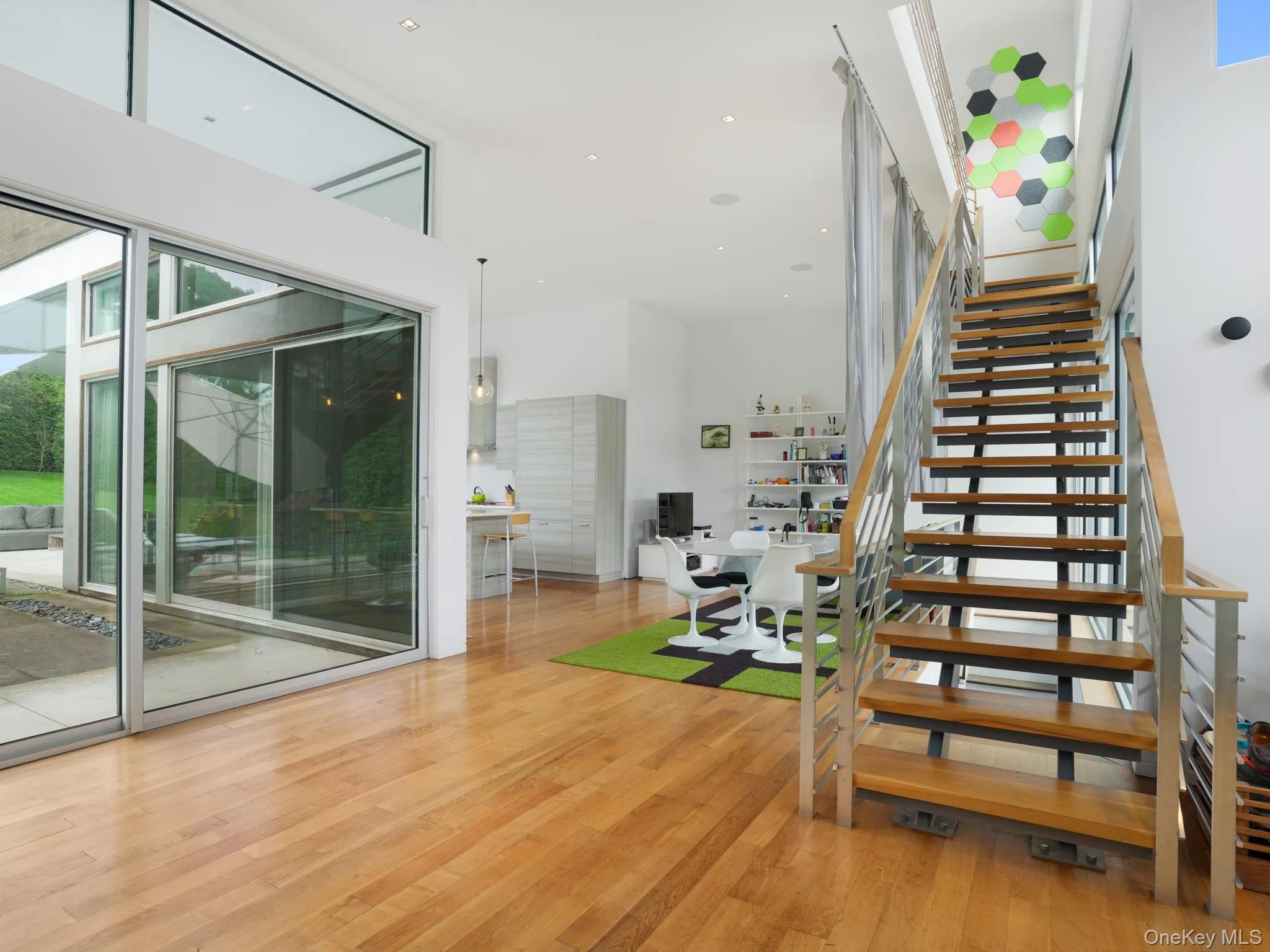 Stairs featuring wood finished floors, recessed lighting, and a towering ceiling Stairs featuring wood finished floors, recessed lighting, and a towering ceiling