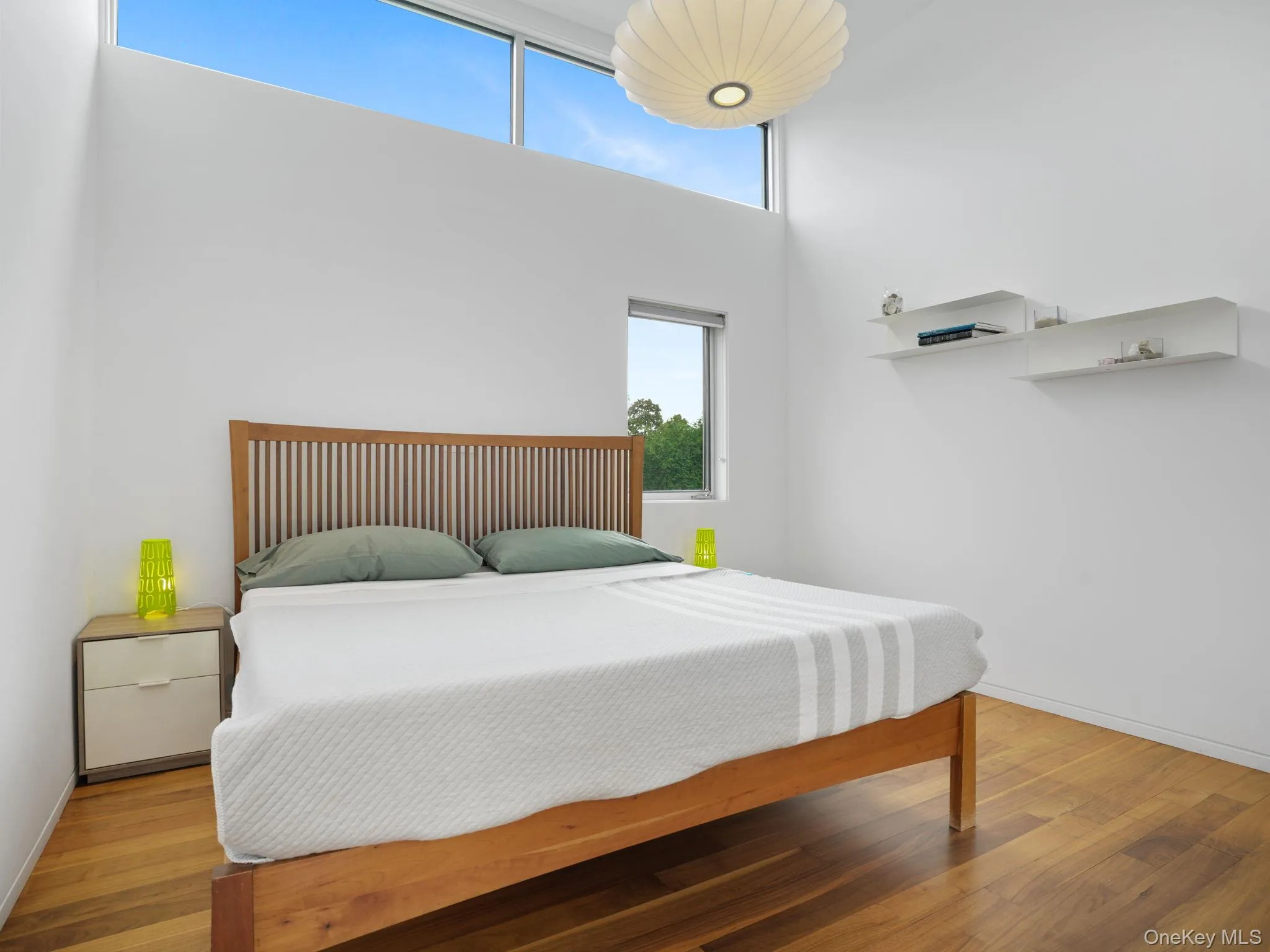 Bedroom with wood finished floors and a high ceiling Bedroom with wood finished floors and a high ceiling