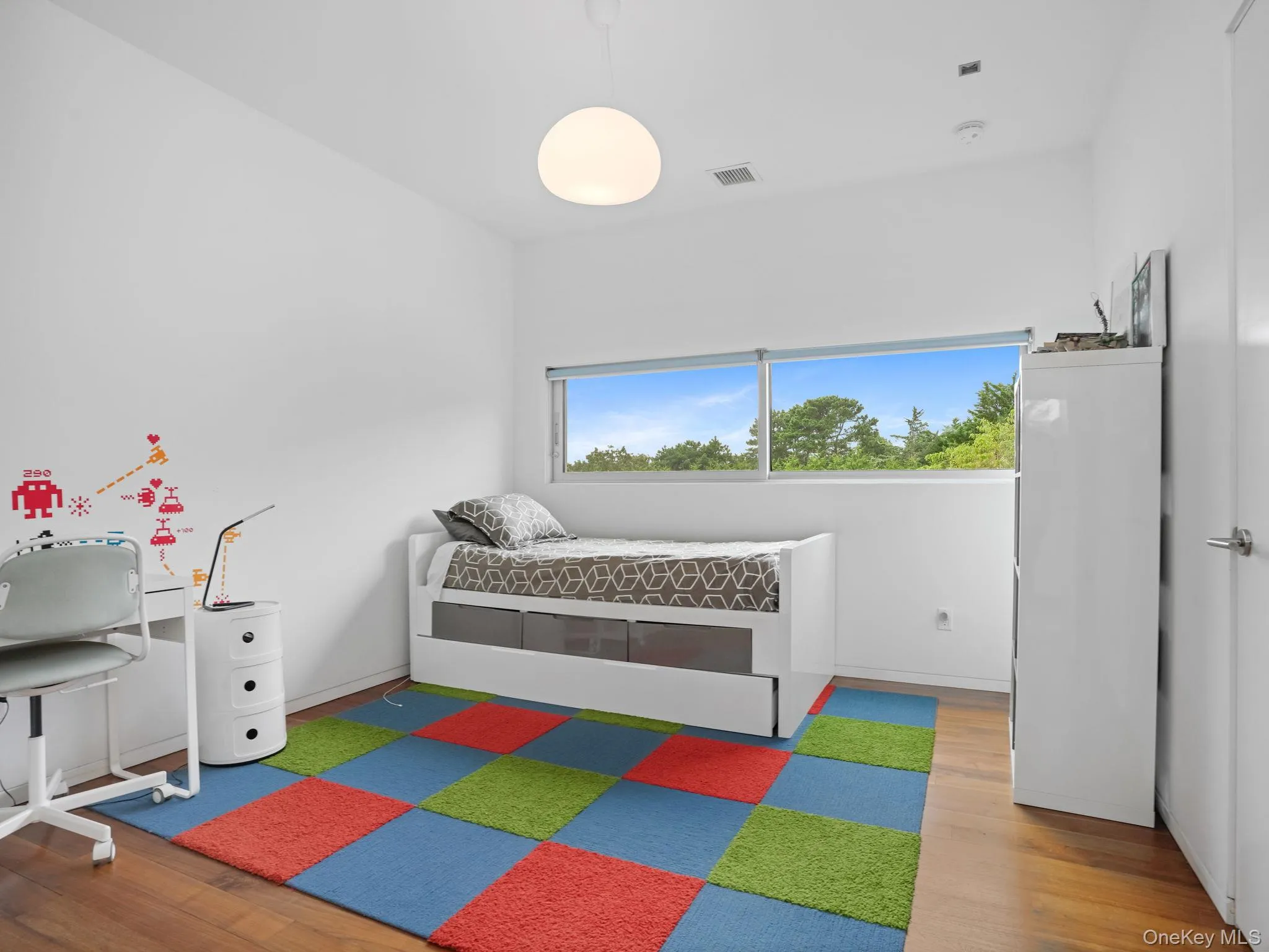 Bedroom with wood finished floors and baseboards Bedroom with wood finished floors and baseboards