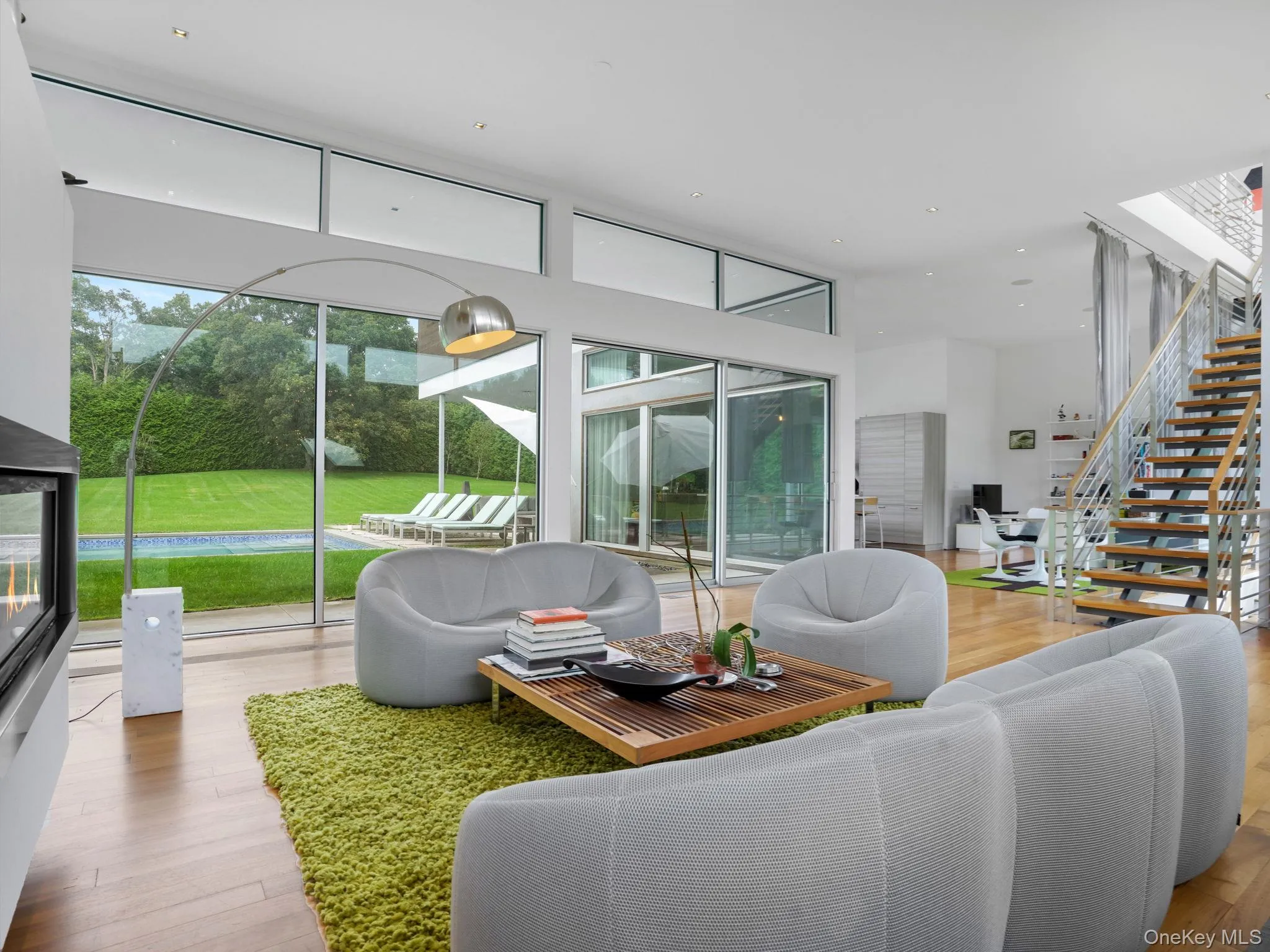 Living area with stairway and wood finished floors Living area with stairway and wood finished floors