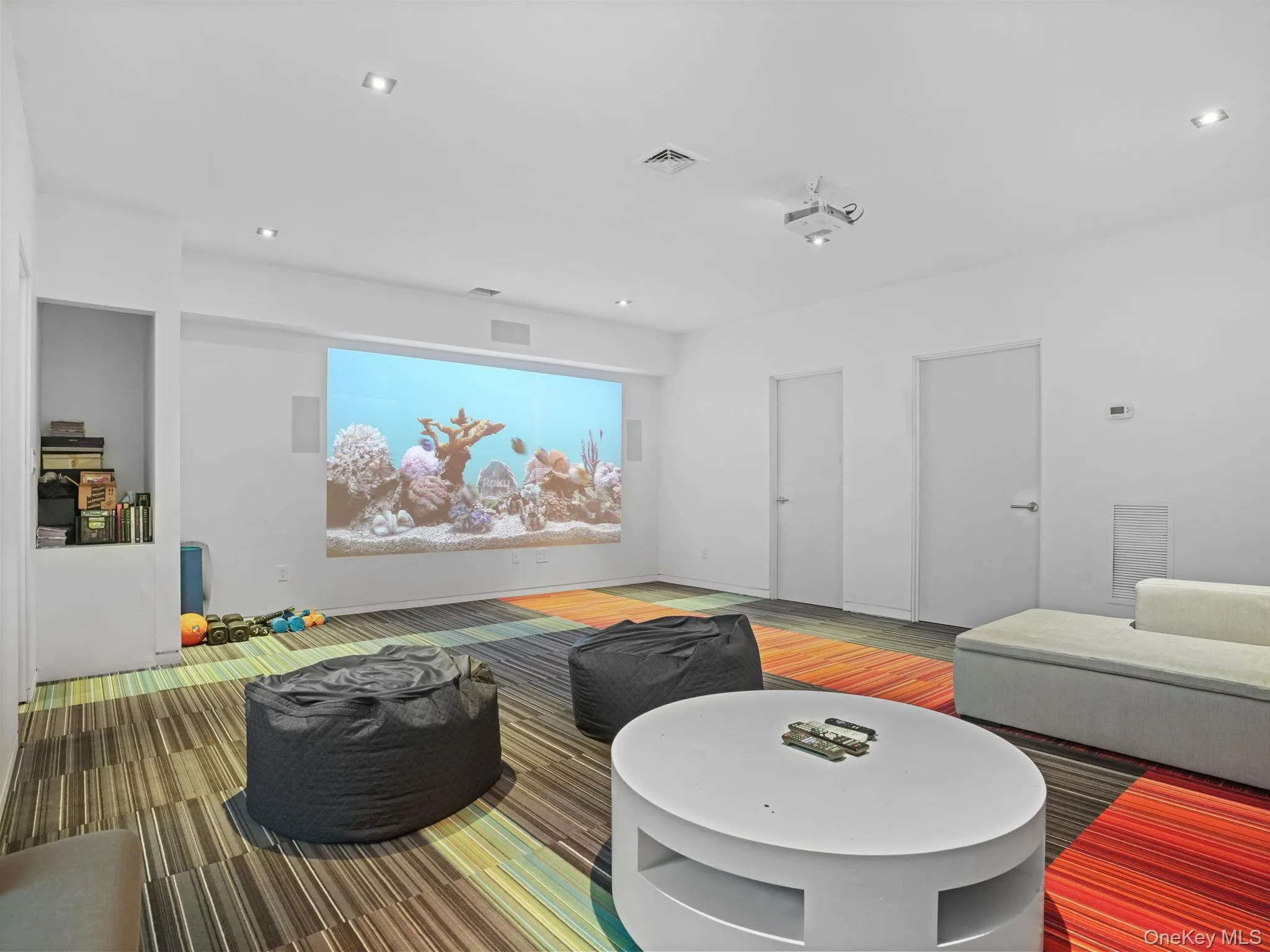 Home theater room featuring recessed lighting and wood finished floors Home theater room featuring recessed lighting and wood finished floors